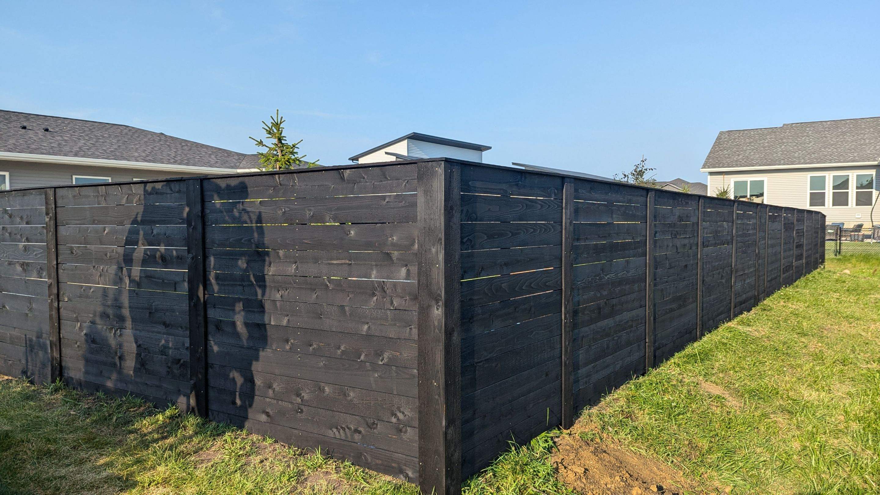 Modern Black Stained Horizontal Privacy Fence Installation in Cedar by Perfect Picket Fence and Stain