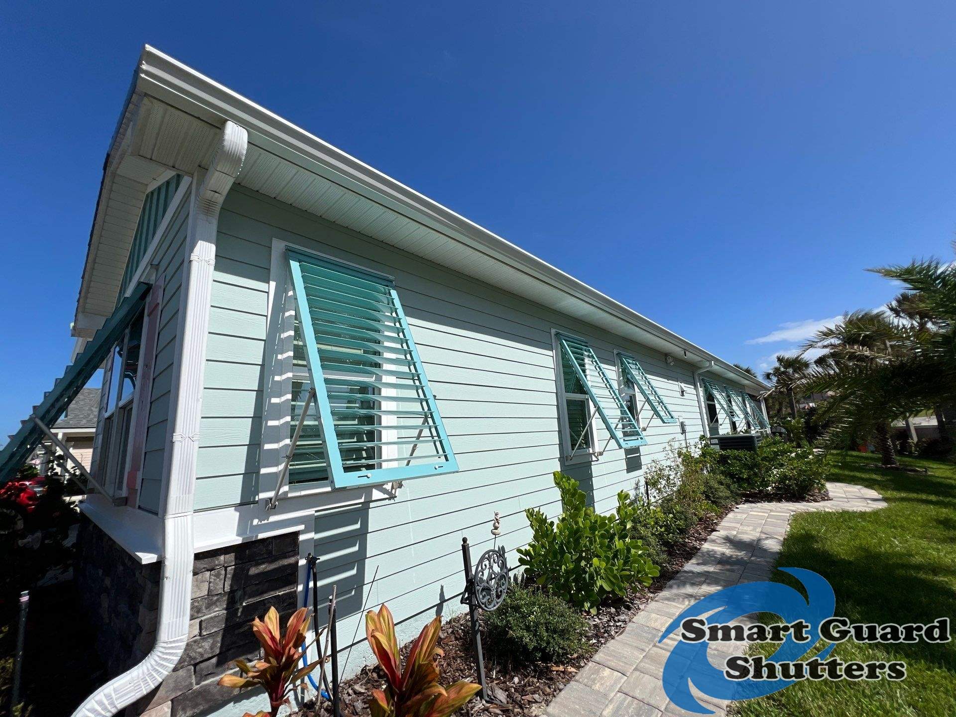 Impact Bahama Shutters in Pastel Turquoise by Smart Guard Shutters
