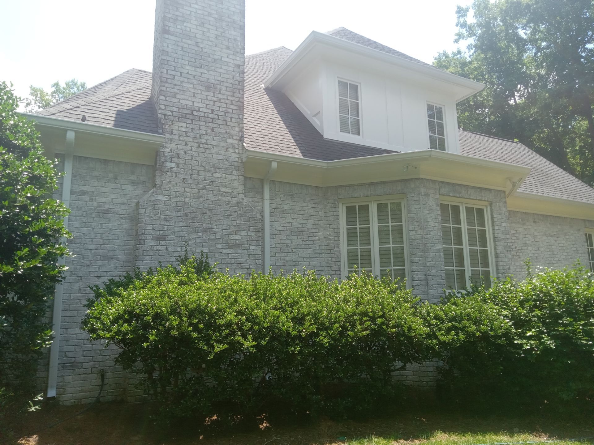 exterior house cleaning including brick siding windows and gutters using high pressure water jets