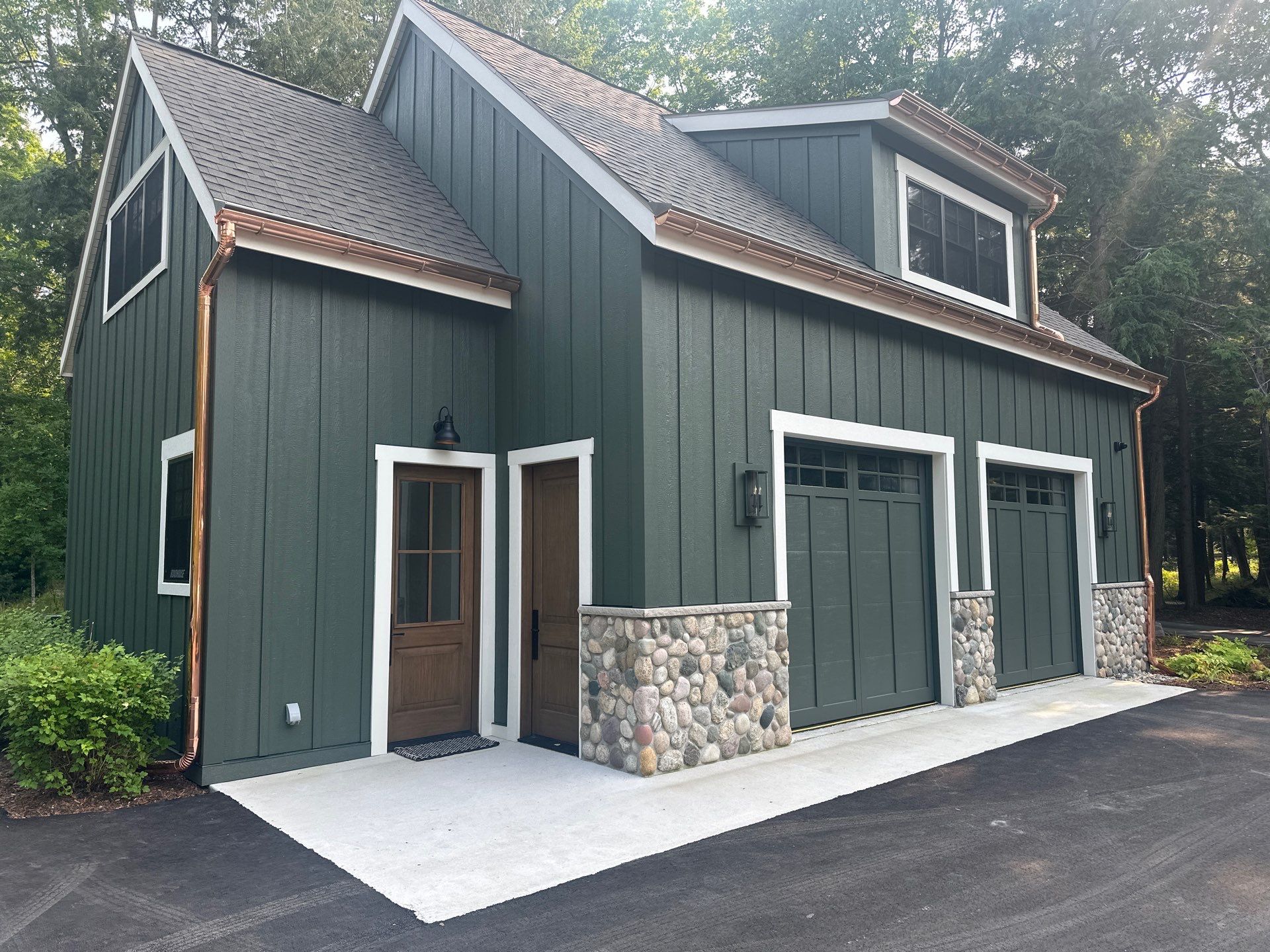 Copper Gutter and Downspout Installation for Omena Residence by Rainbow Seamless Systems