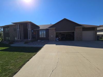 Dark Blue Exterior Home Painting and Siding Refresh in Sioux Falls