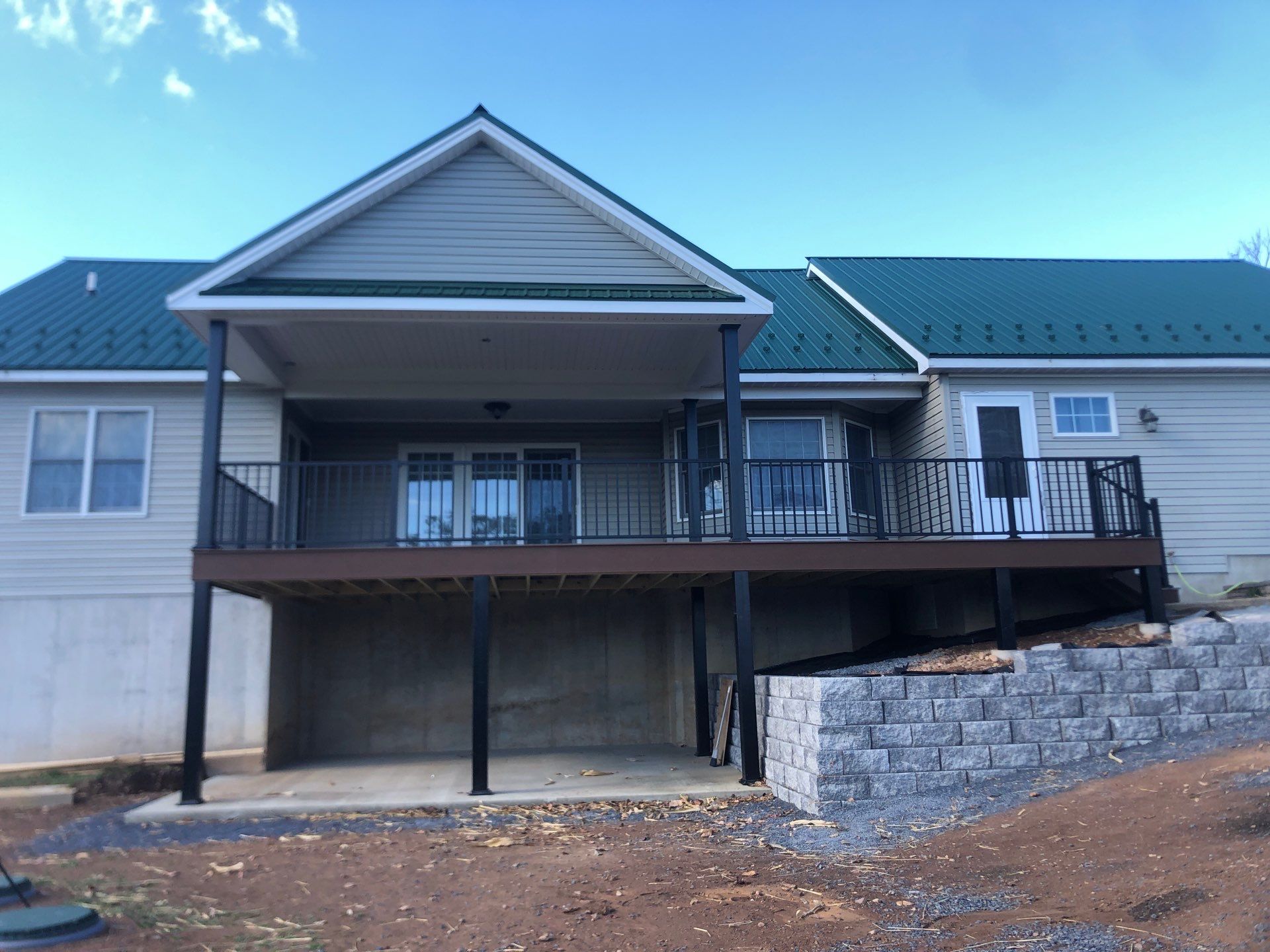 Green Metal Roof and Custom Covered Deck in Duncannon by Esh Builders
