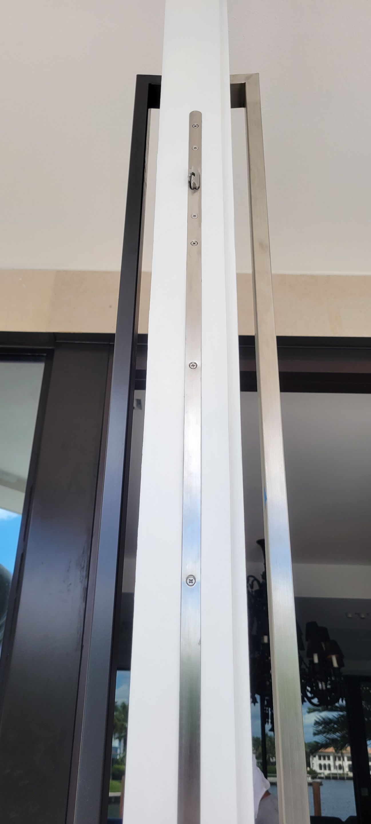 Custom Material Pivot Door installation by Impact Precious Wood Inc.