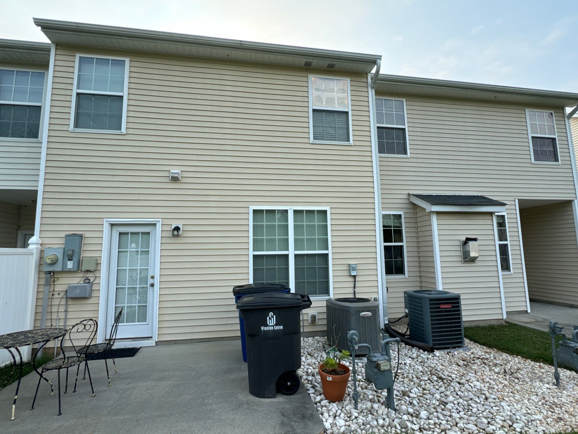 pressure washing exterior siding of a residential building to clean and restore appearance