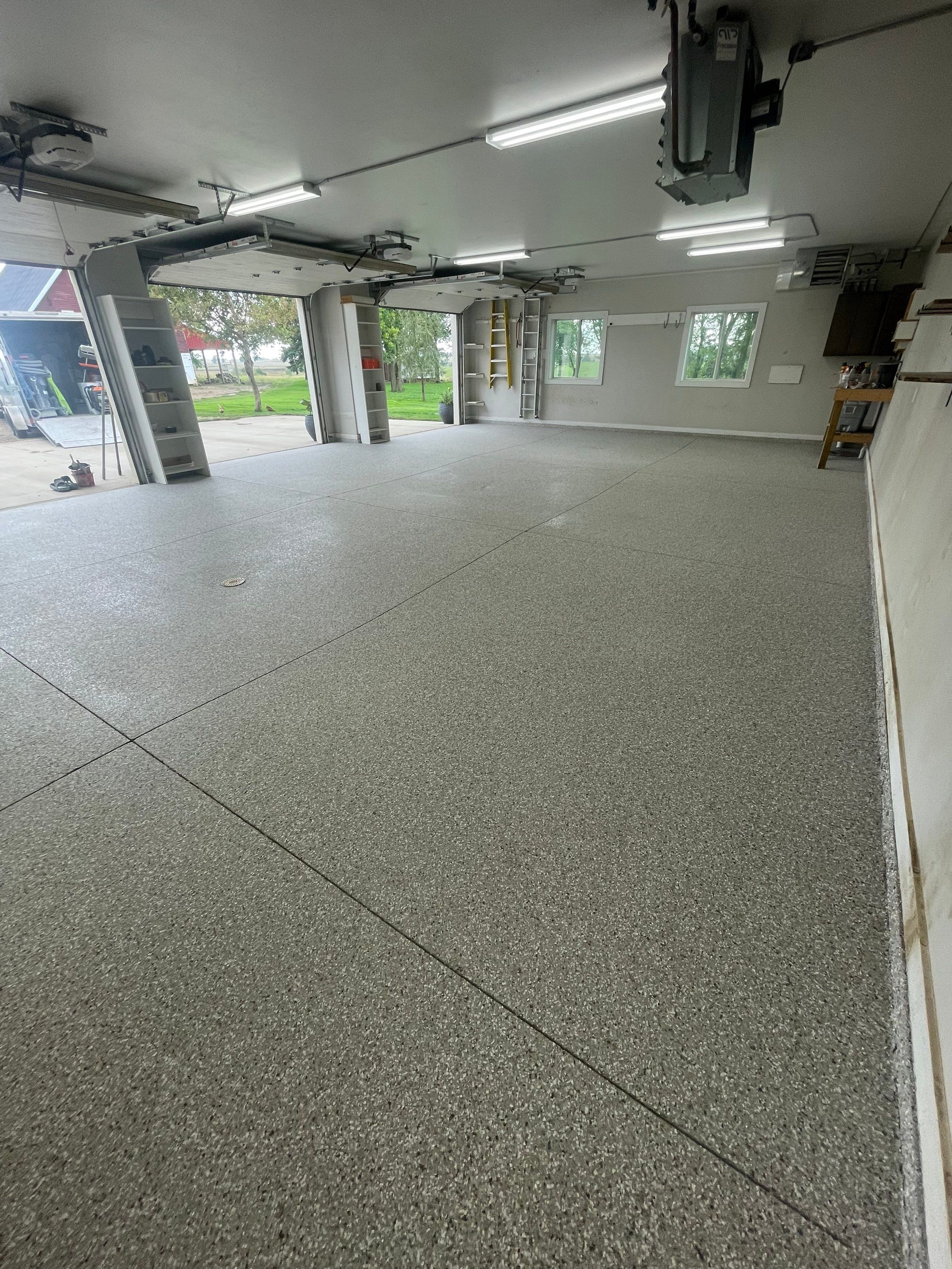 Grey Speckled Polyuera Garage Floor Coating for Hartford Three-Car Garage by Select Painting, Coatings & Garage Cabinets