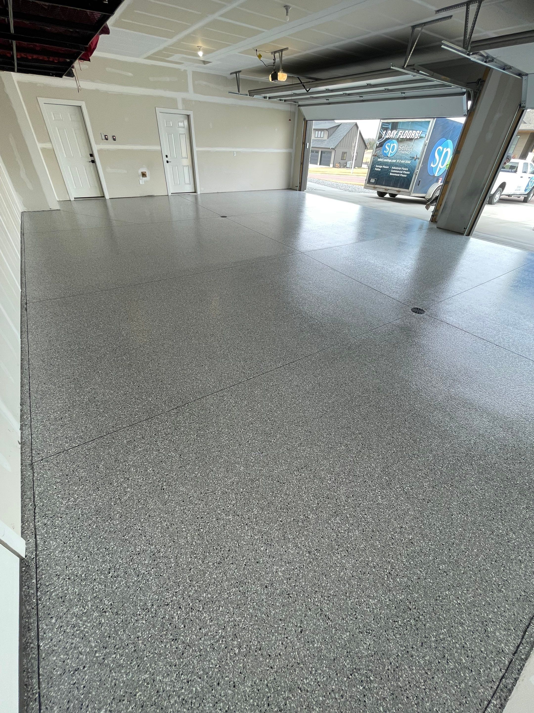 Grey Speckled Epoxy Floor Coating for Sioux Falls Garage by Select Painting, Coatings & Garage Cabinets