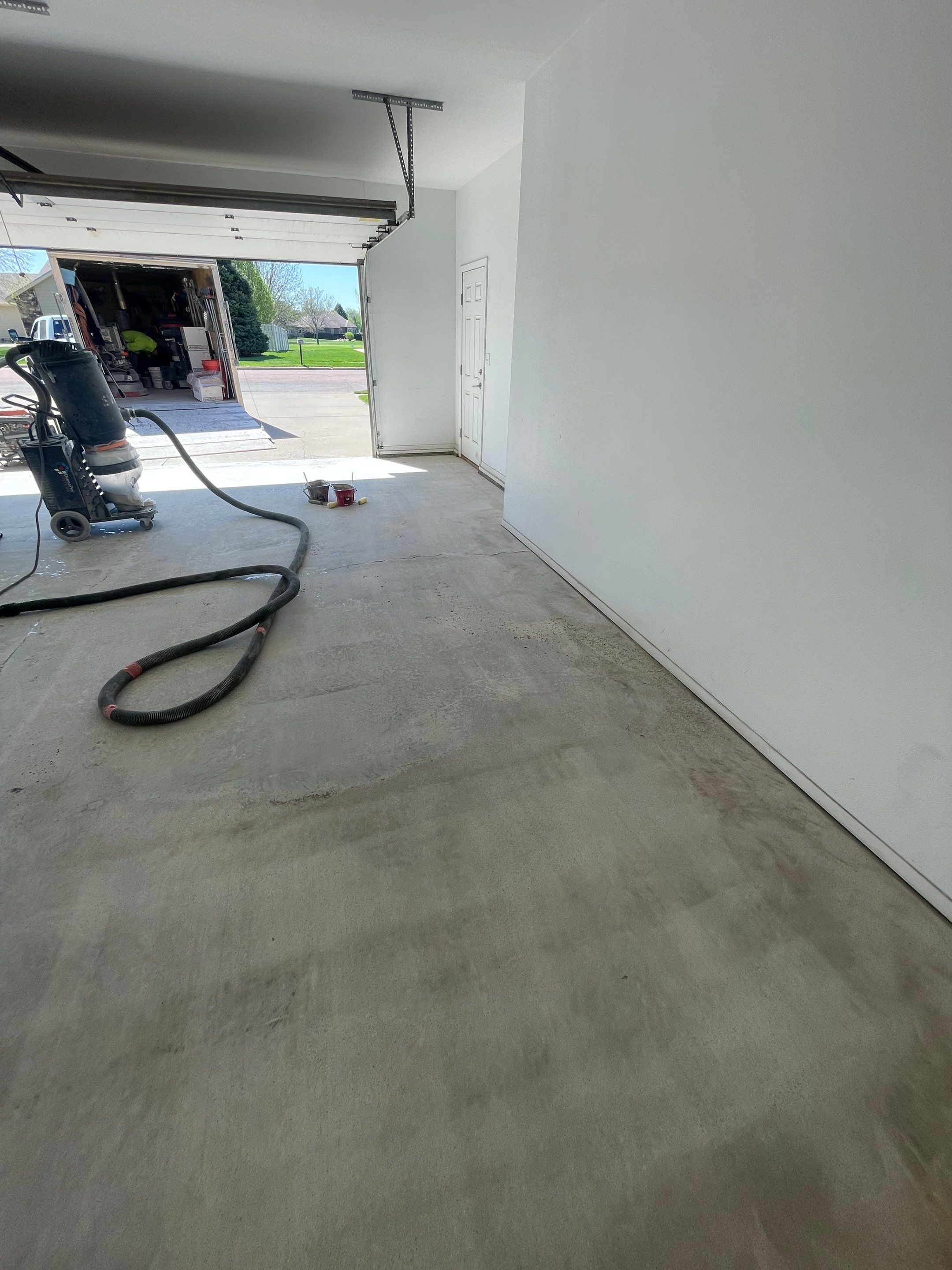 Yankton Garage Floor Restoration with Gray Speckled Epoxy Coating by Select Painting, Coatings & Garage Cabinets