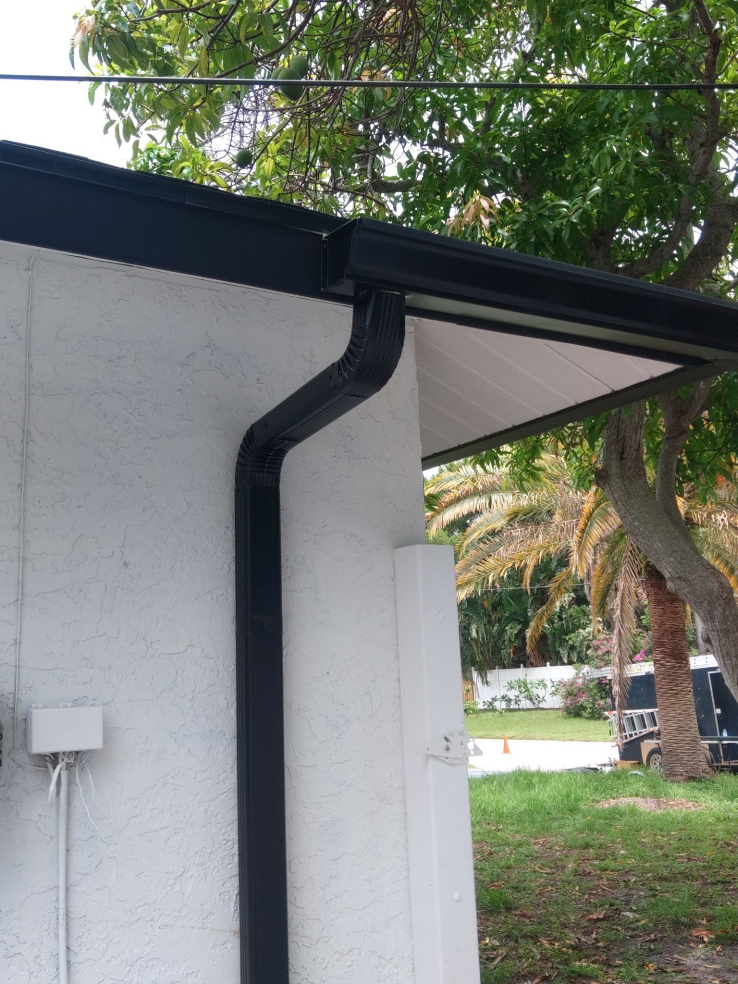 Black seamless gutters and downspouts installation in Sarasota, FL by Gutter Professors