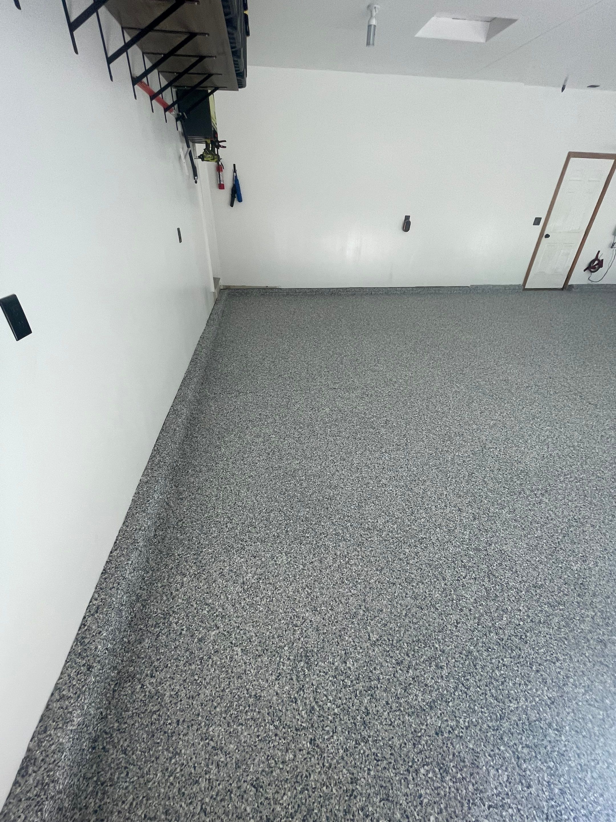Tidal Wave Flake Garage Floor Installation in Sioux Falls by Select Painting, Coatings & Garage Cabinets