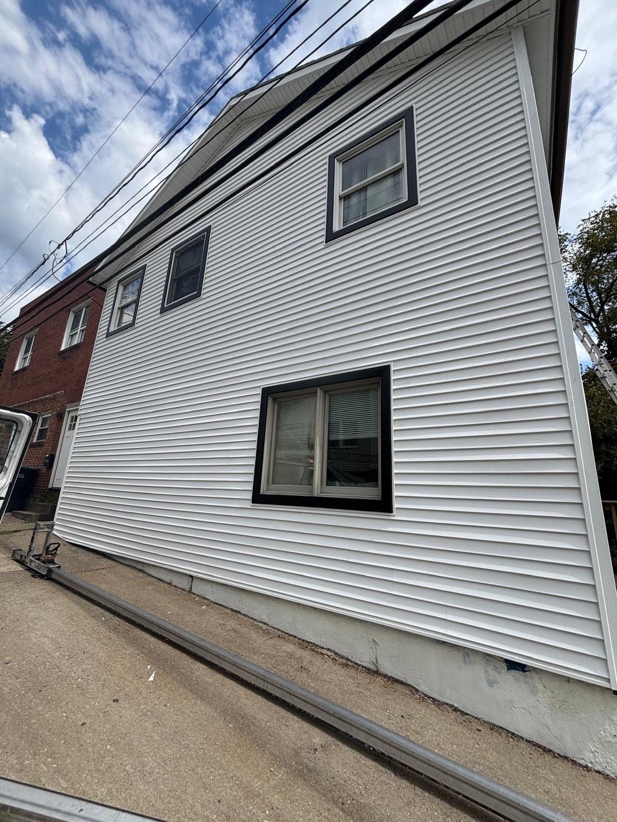 White siding  by Cousins Roofing Siding & Decks