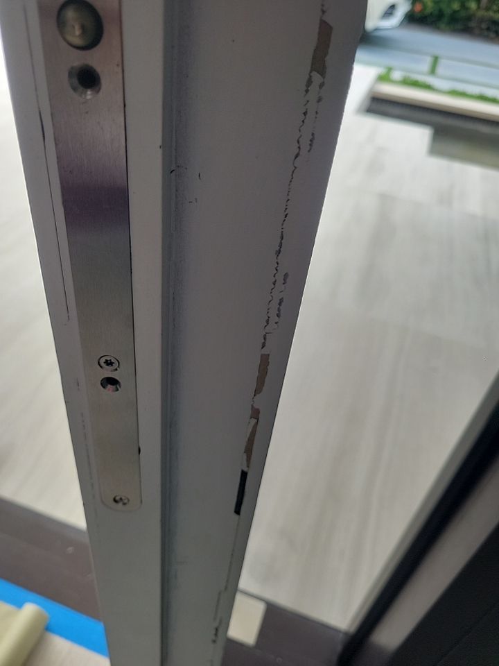 Custom Material Pivot Door installation by Impact Precious Wood Inc.