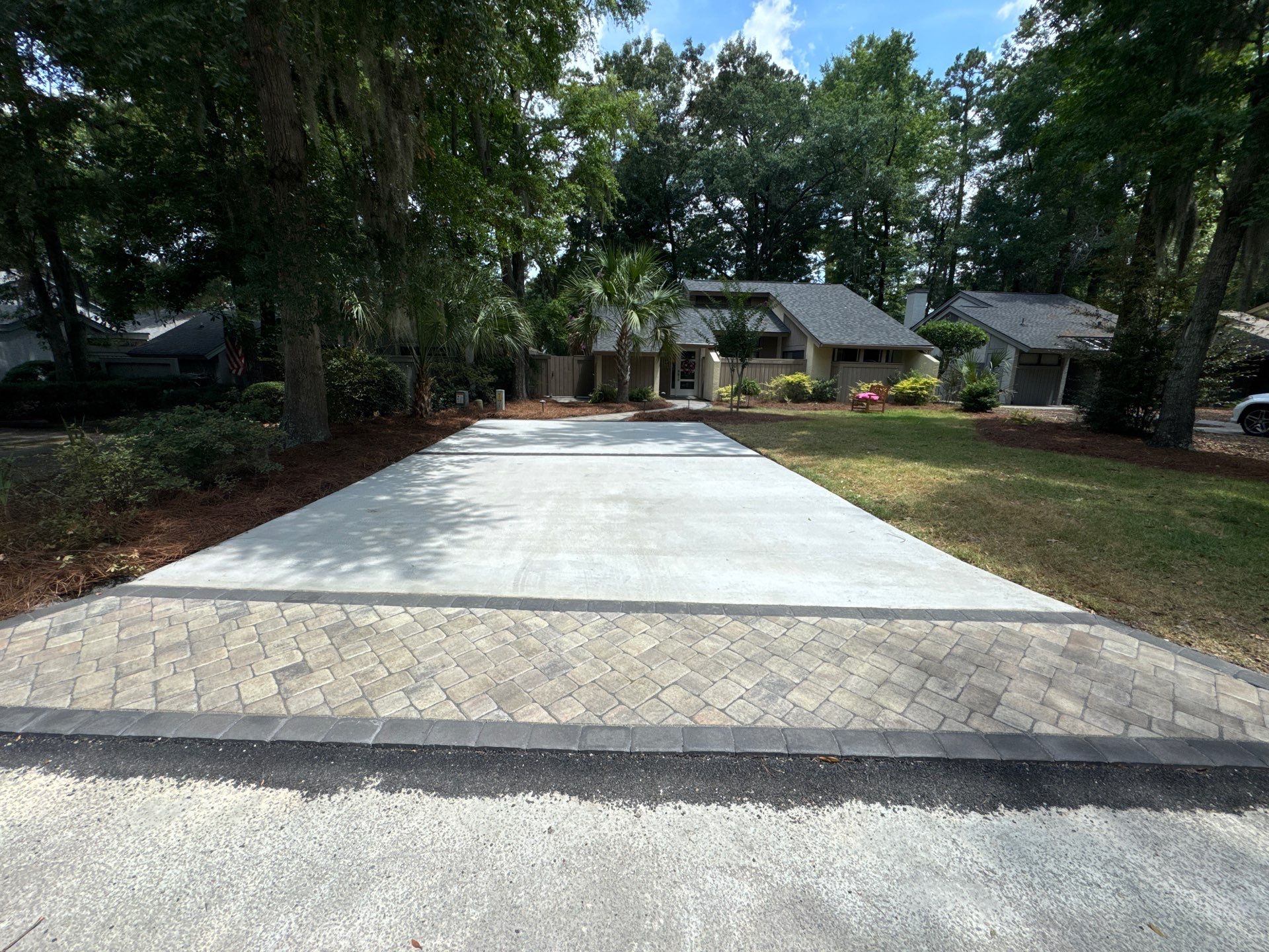 Custom Concrete Patio and Herringbone Paver Walkway in Hilton Head Island by Lowcountry Scapes, LLC