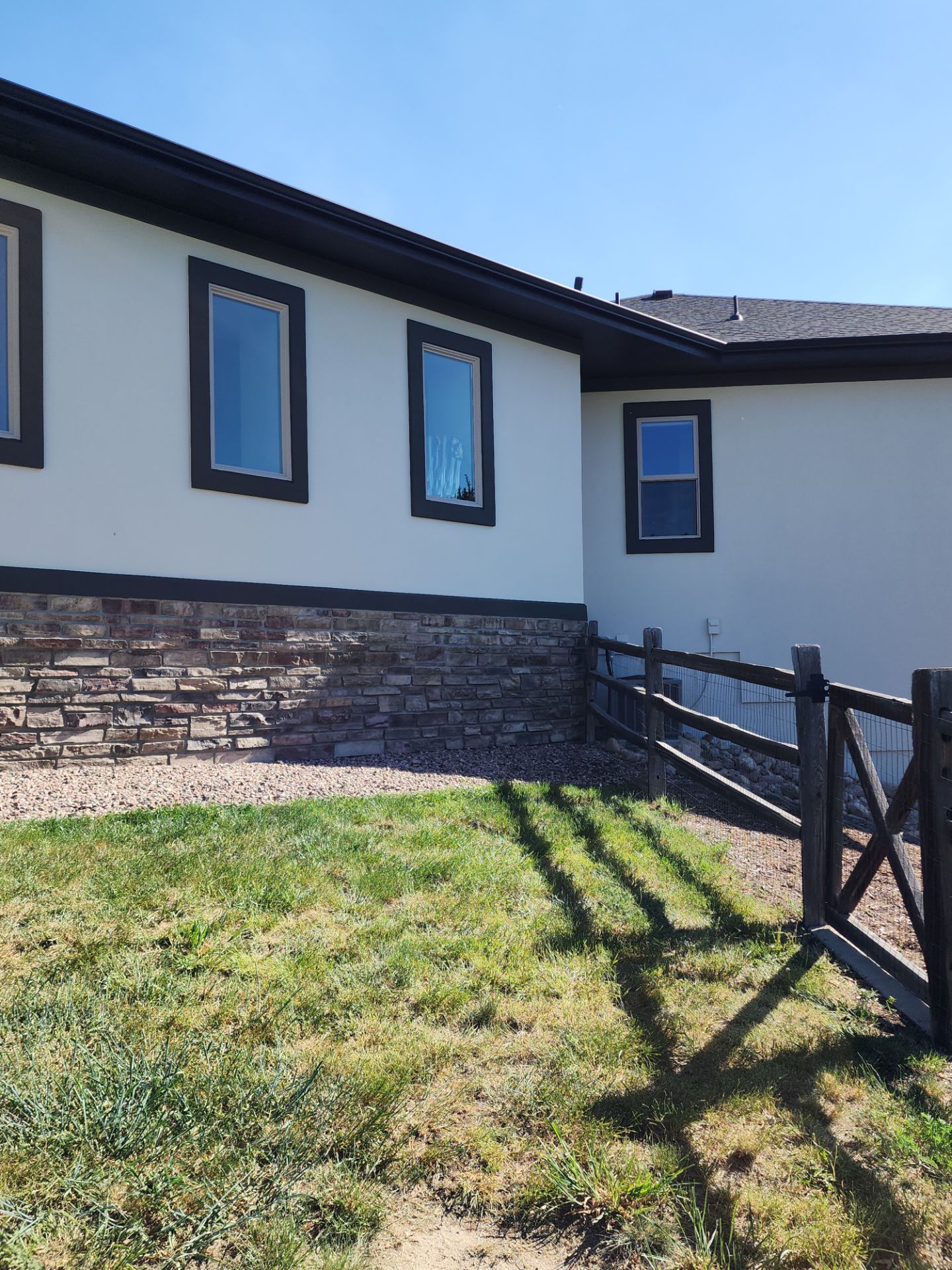 Castle Rock Elegance: White Stucco Exterior with Bold Tricorn Black by J&M Painting LLC