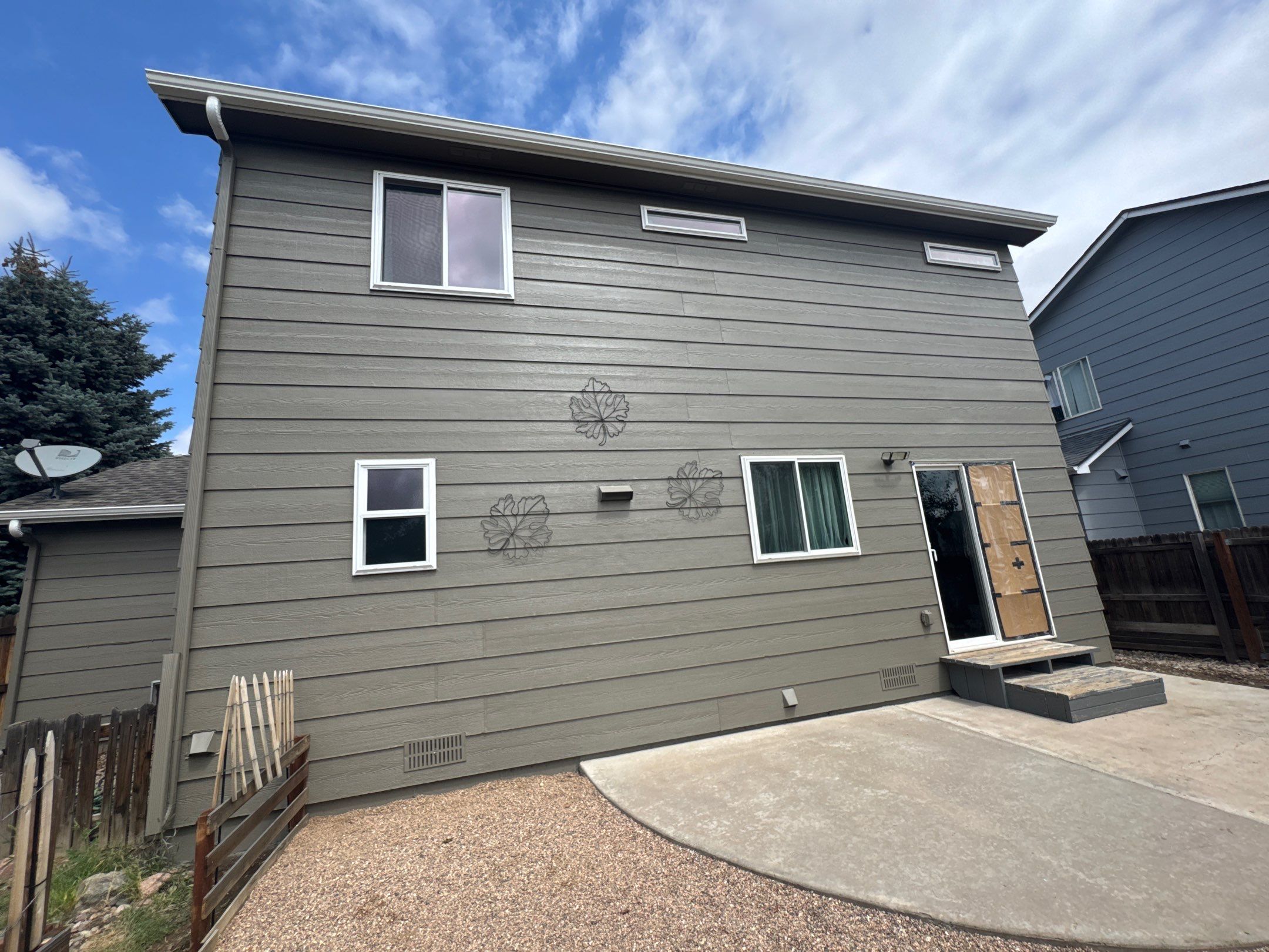 Exterior siding and trim paint on significantly sun damaged home in Cimarron Hills by Carroll Painting LLC