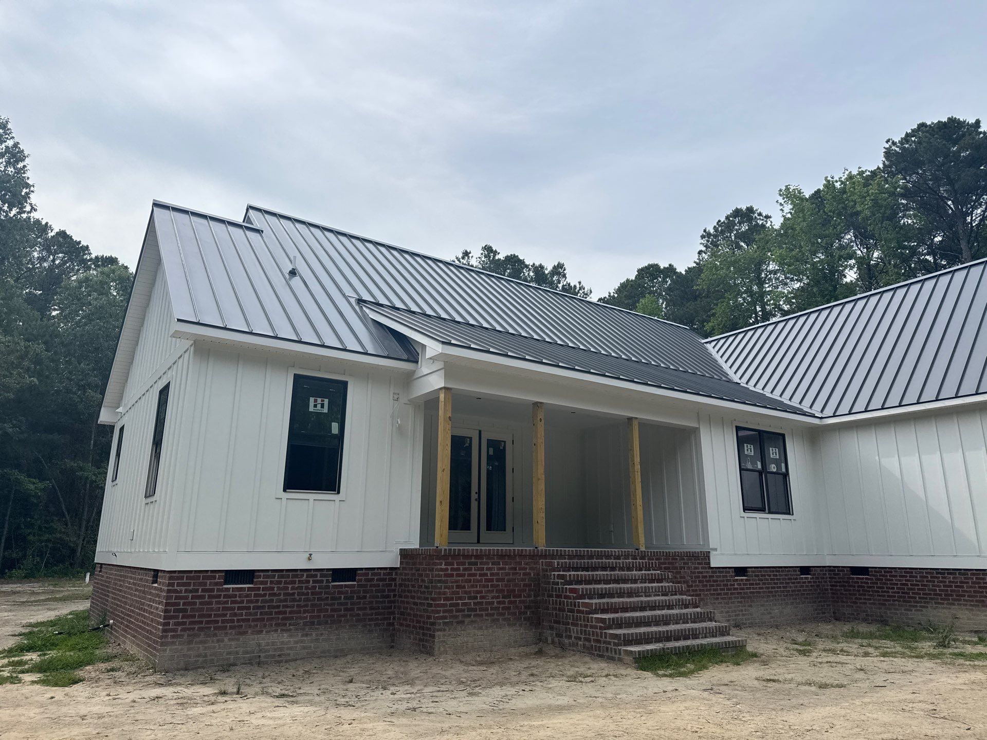 Custom New Construction Home Featuring Standing Seam Metal Roofing in Port Haywood by Cade Construction