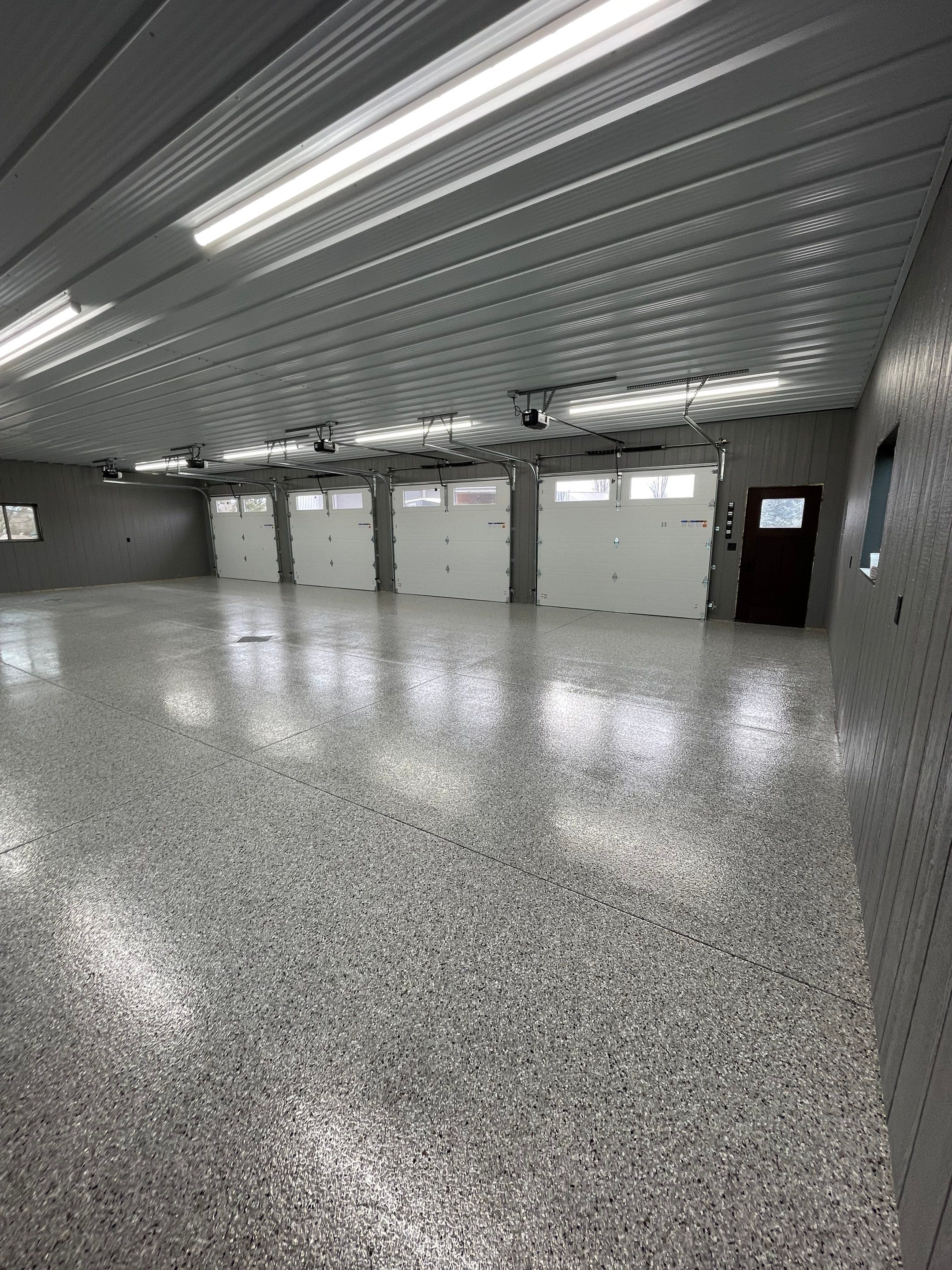 Speckled Epoxy Floor Coating for Large Shop in Rock Valley by Select Painting, Coatings & Garage Cabinets
