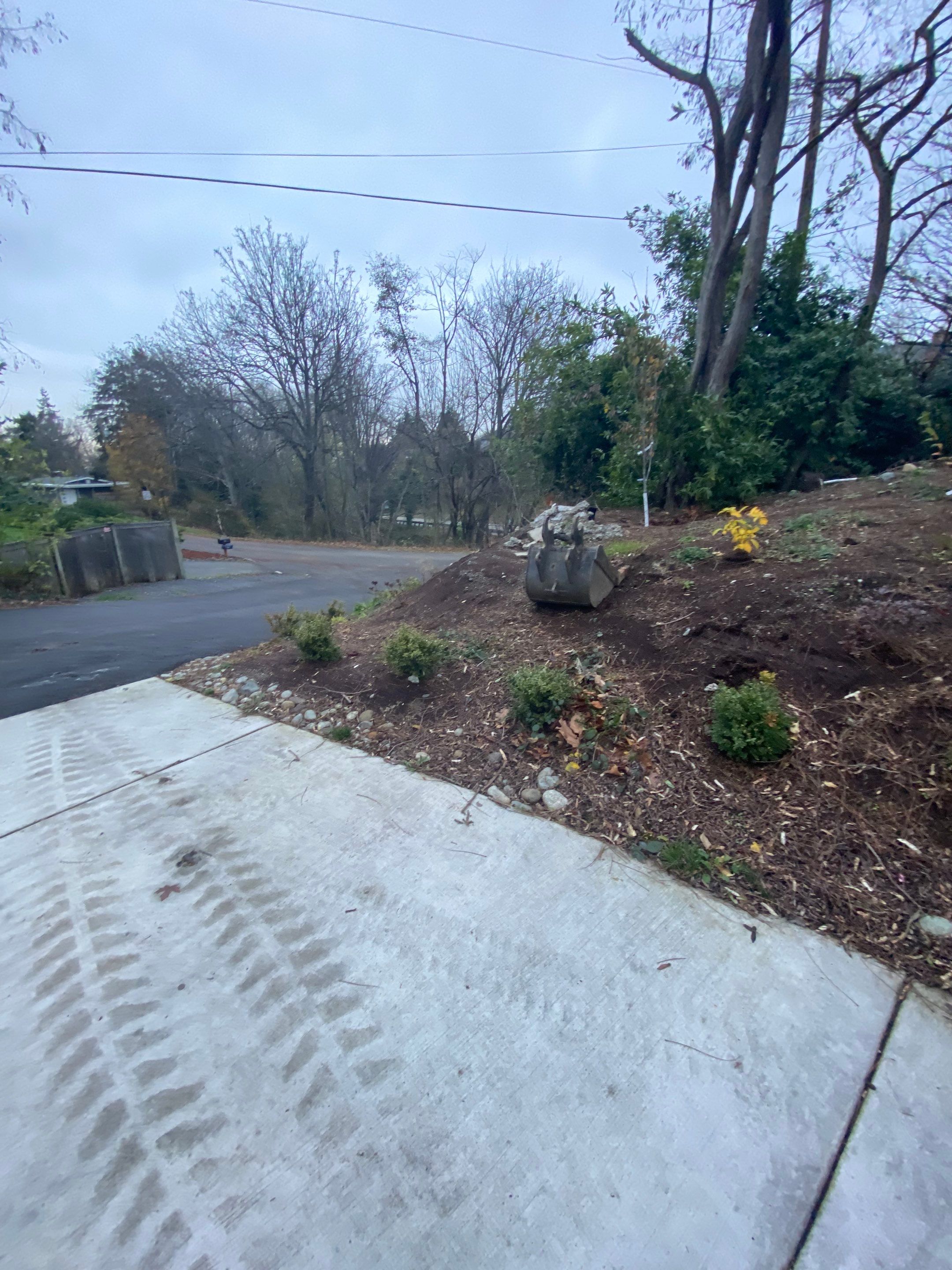 Patio Installation using Concrete, Retaining walls, and Turf install by Jireh Asphalt & Concrete Inc 