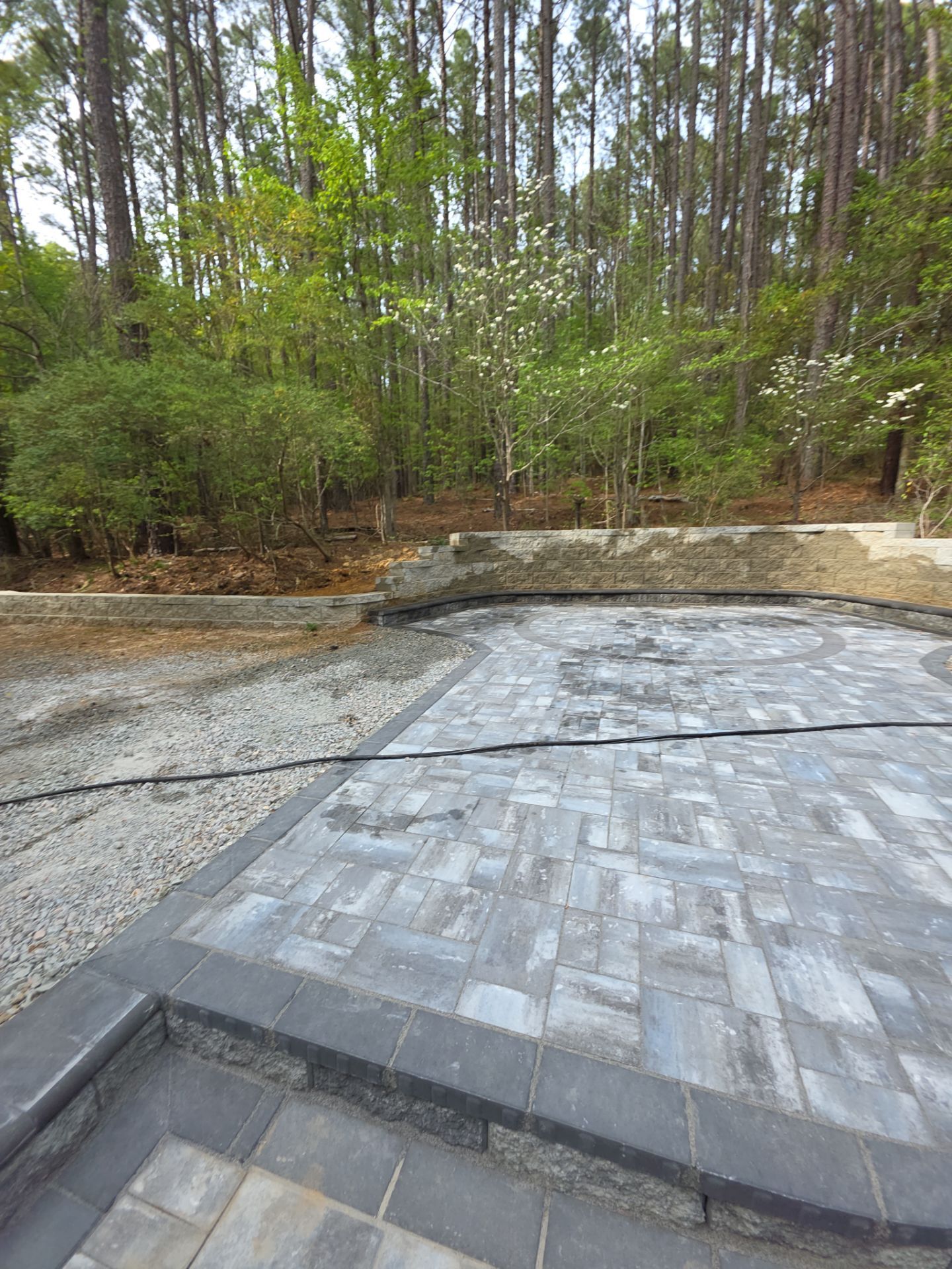 Pittsboro Outdoor Living Transformation – Retaining Wall, Paver Patio & Elevated Deck by Elite Remodeling and Design LLC