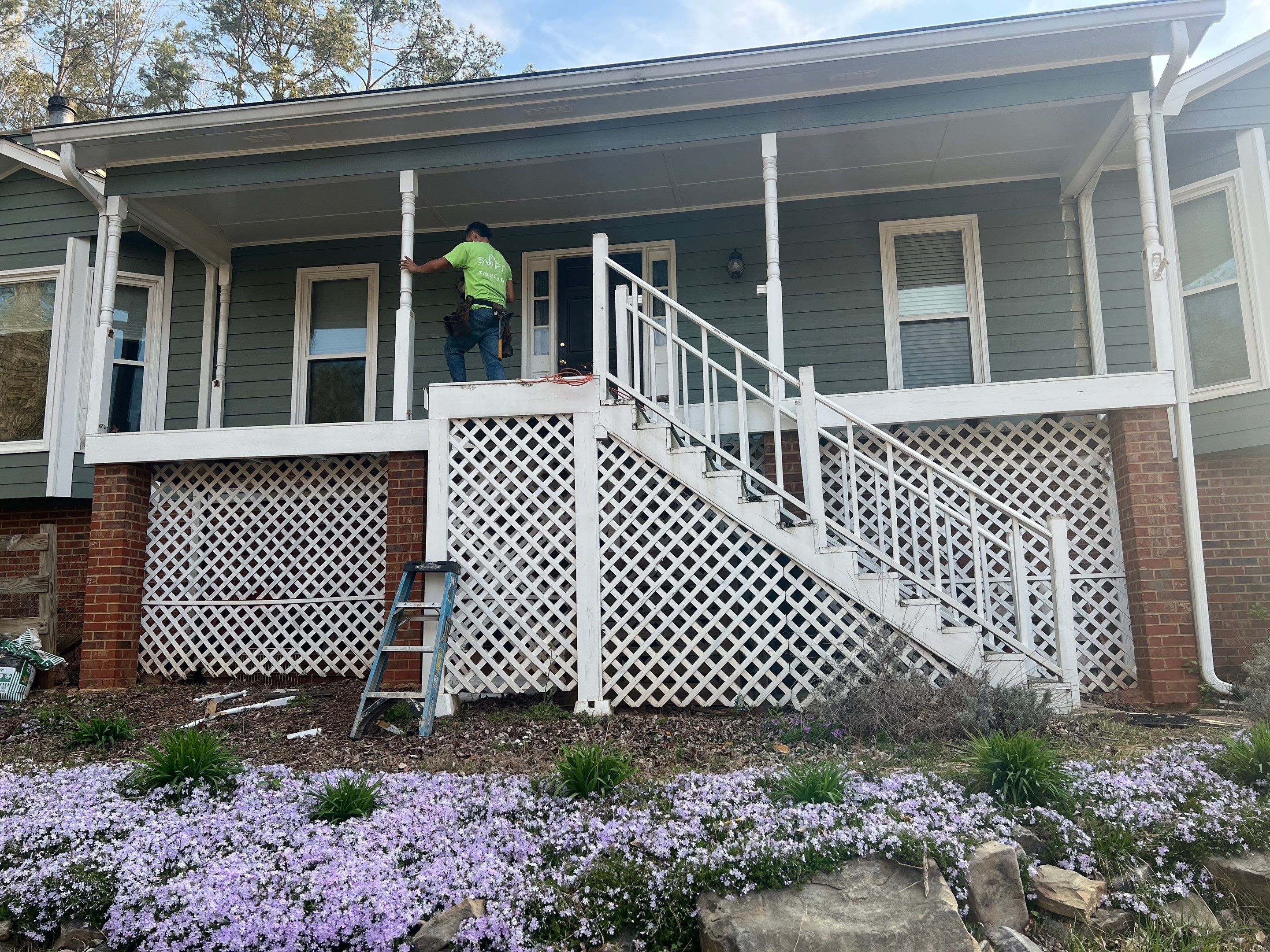 Composite Deck and Porch Renovation With Black Metal Railings by Swift Home Renovations 