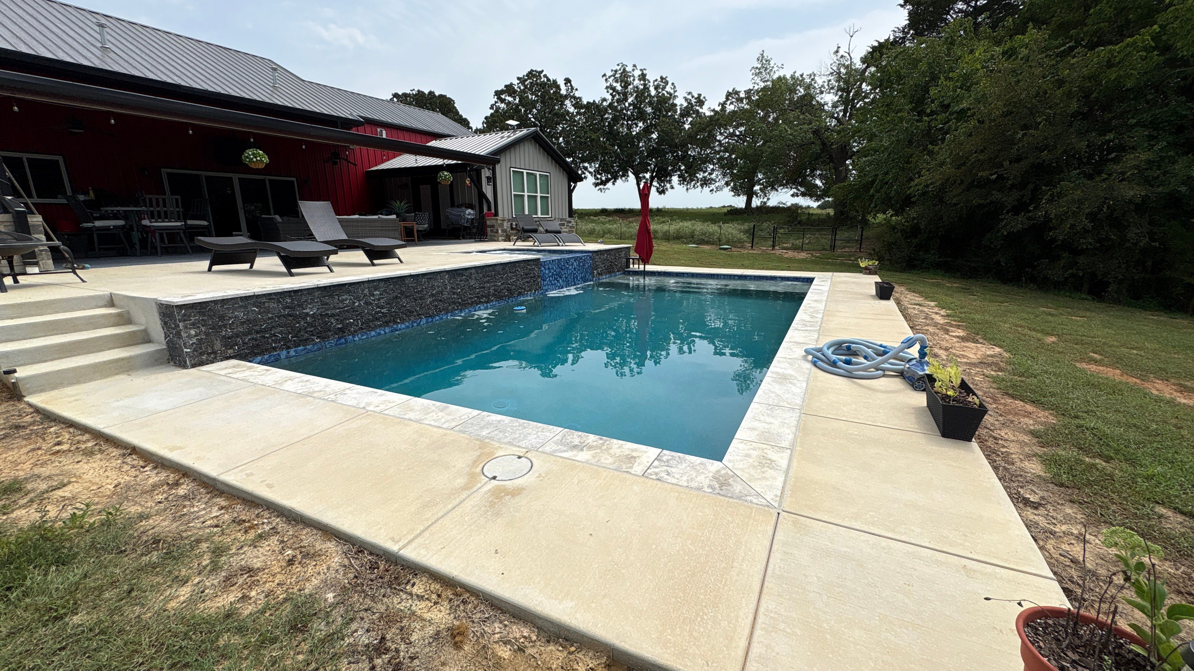 Sleek Rectangular Pool with Dark Interior Finish by Pinnacle Pools and Spas - DFW