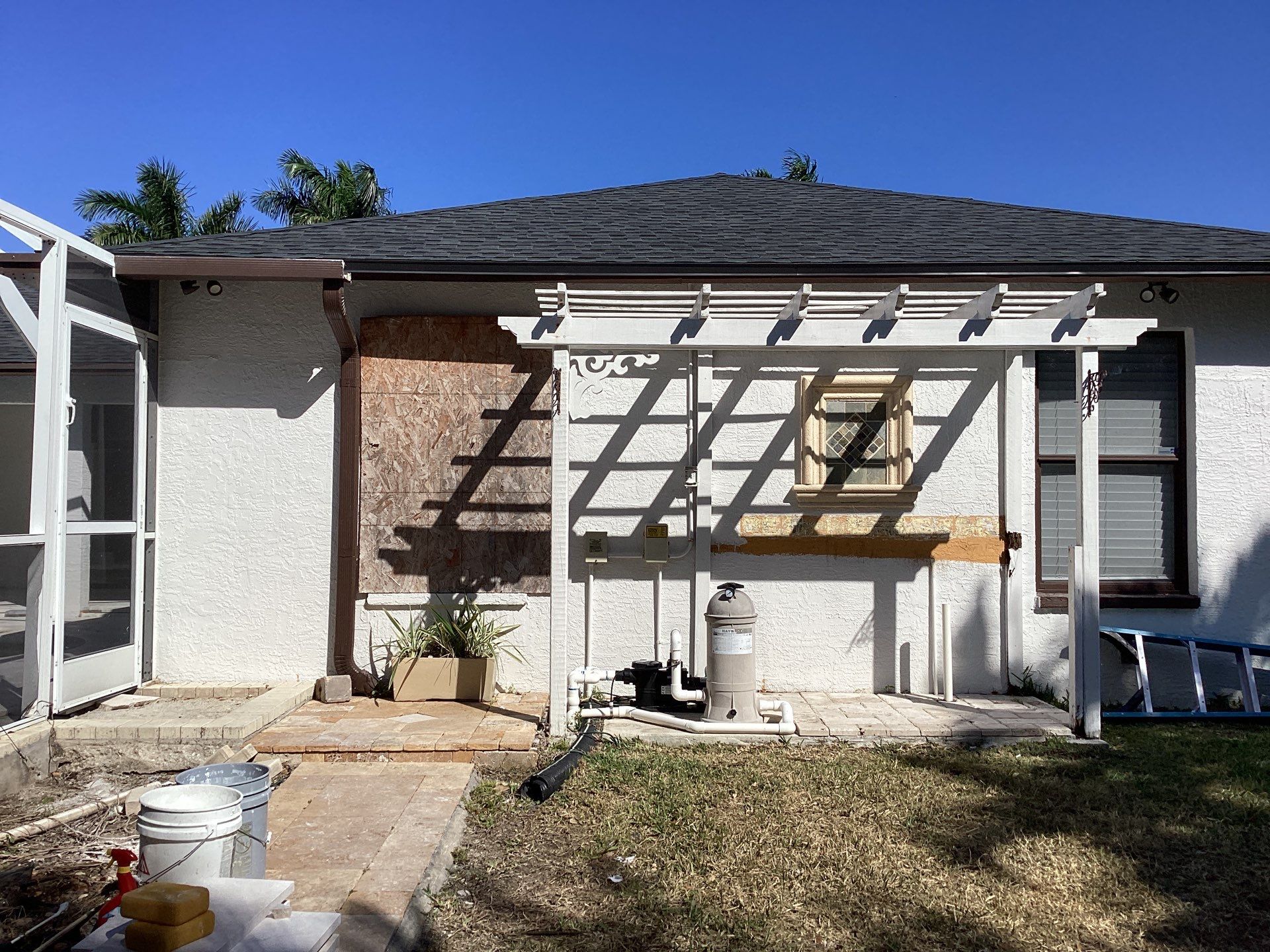 Brown Gutter + White and Brown Downspouts in Cape Coral FL by Gutter Professors