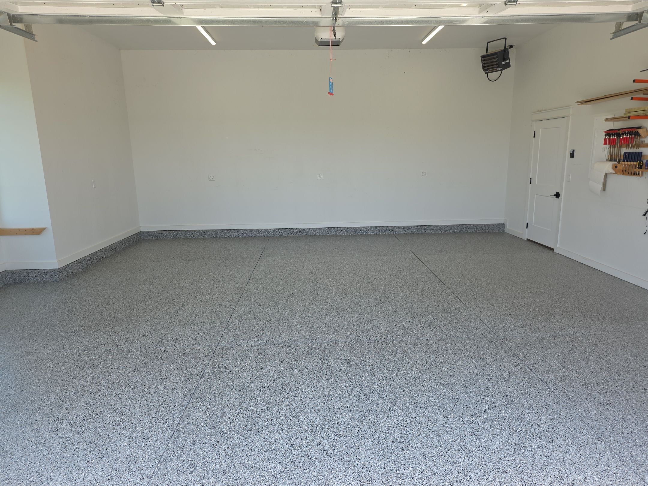 Ames Garage Floor Transformation with Gray and White Speckled Epoxy by Revival Concrete Coatings