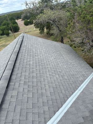 Architectural asphalt shingle roof with a metal valley flashing.