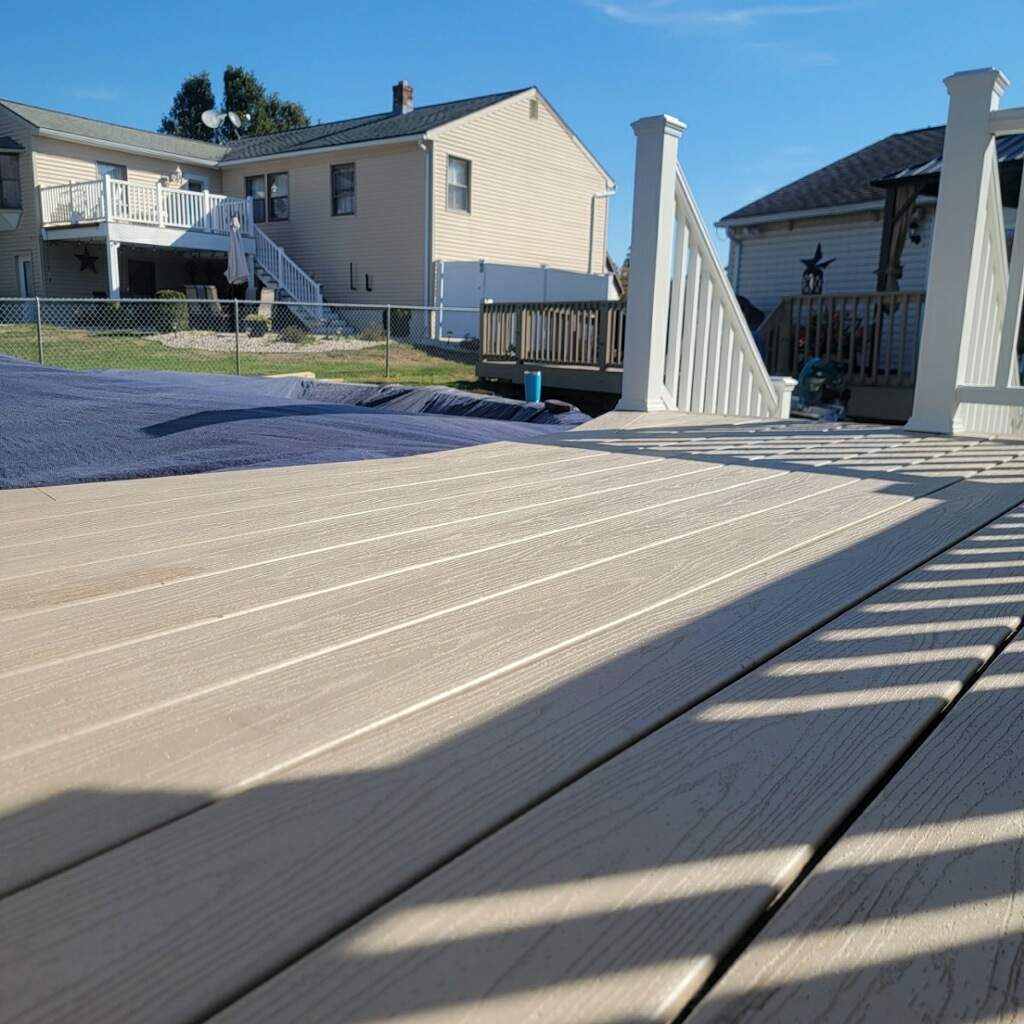 New pool deck and main deck resurface using Trex Transcend Rope Swing boards, White railing and Lattice by DiGiorgi Roofing and Siding Inc