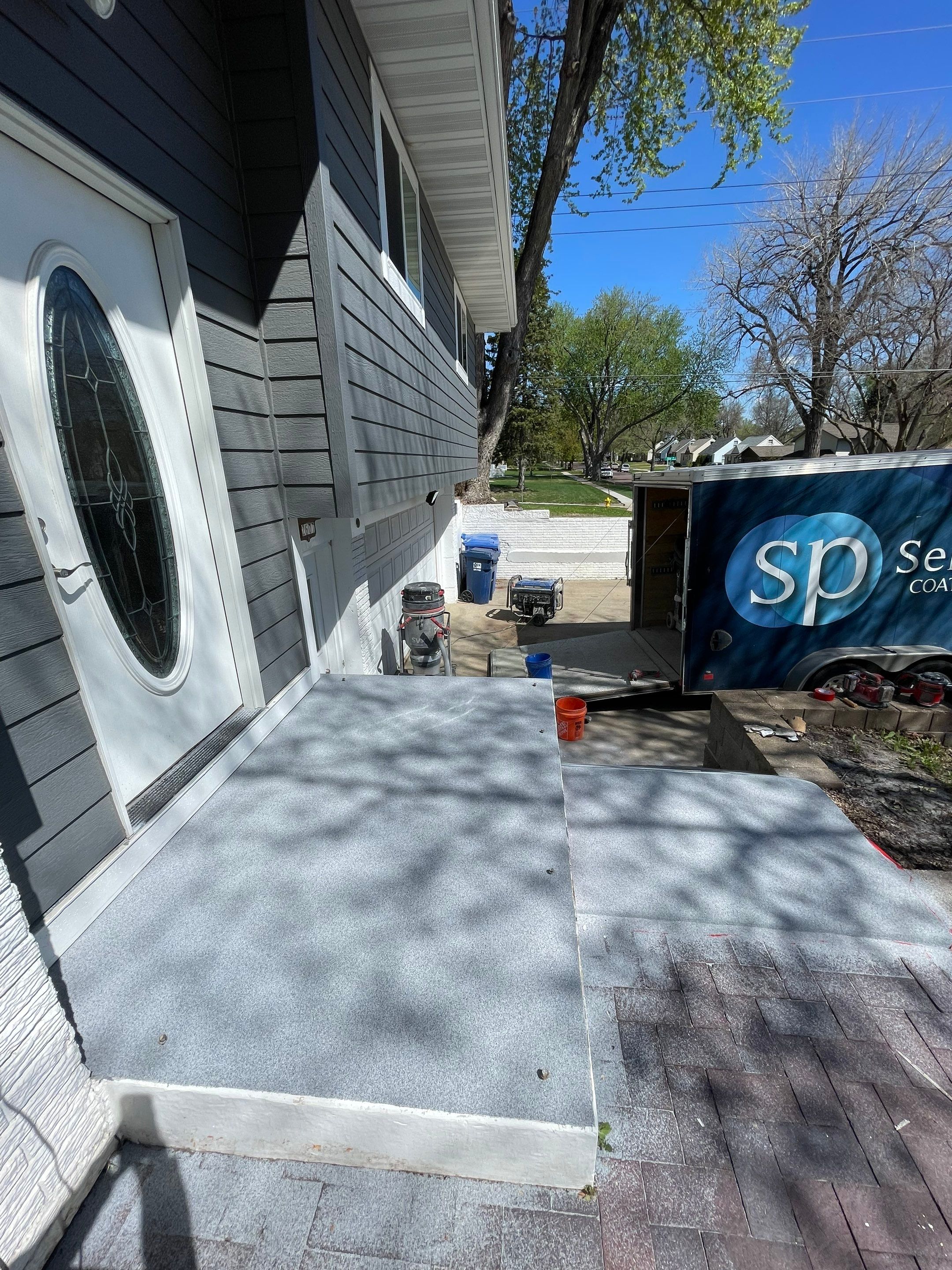 Grey Polyaspartic Porch and Stair Resurfacing in Sioux Falls by Select Painting, Coatings & Garage Cabinets