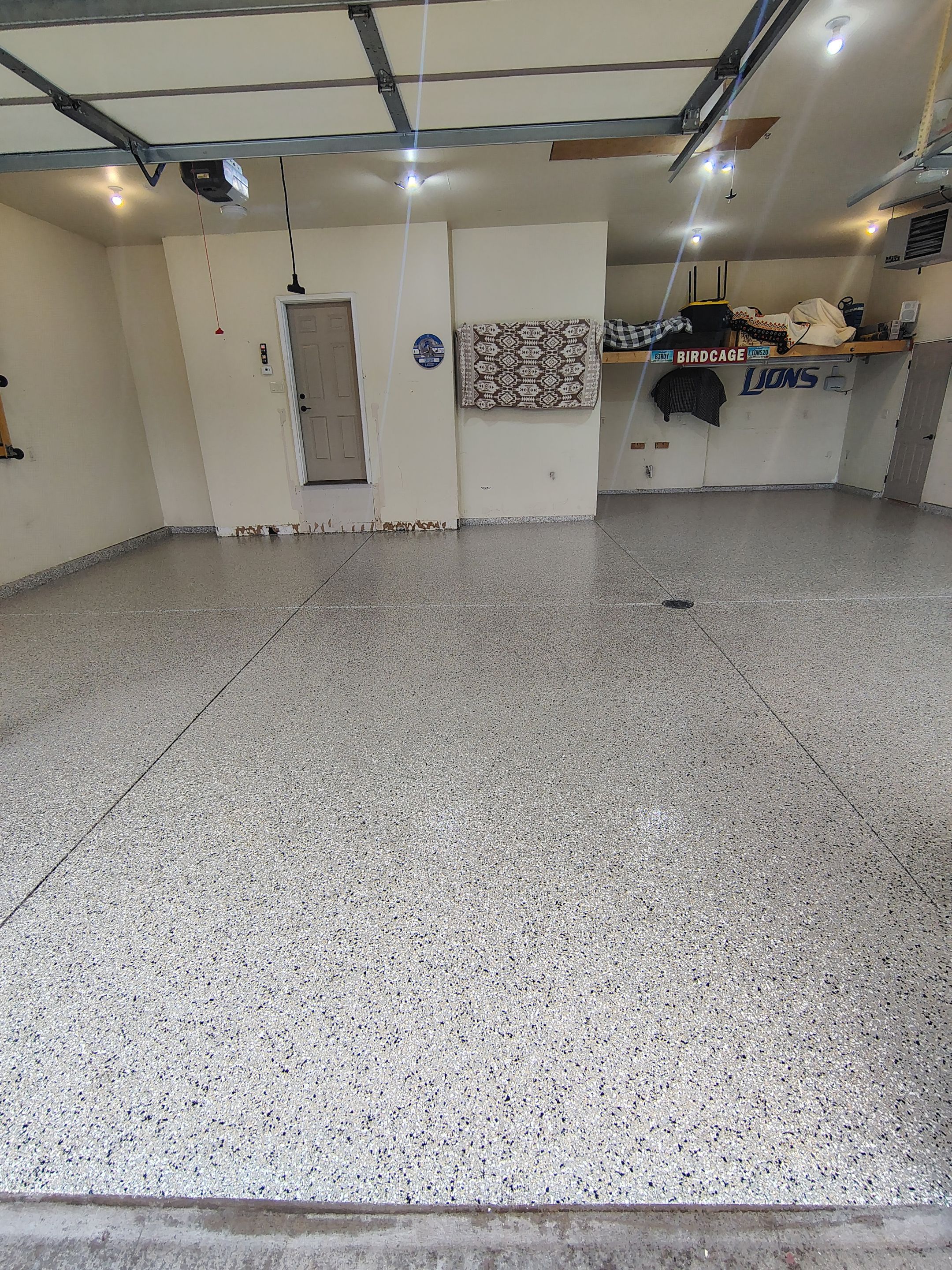 Sioux Falls Garage Floor Repair and Speckled Epoxy Coating Installation by Select Painting, Coatings & Garage Cabinets