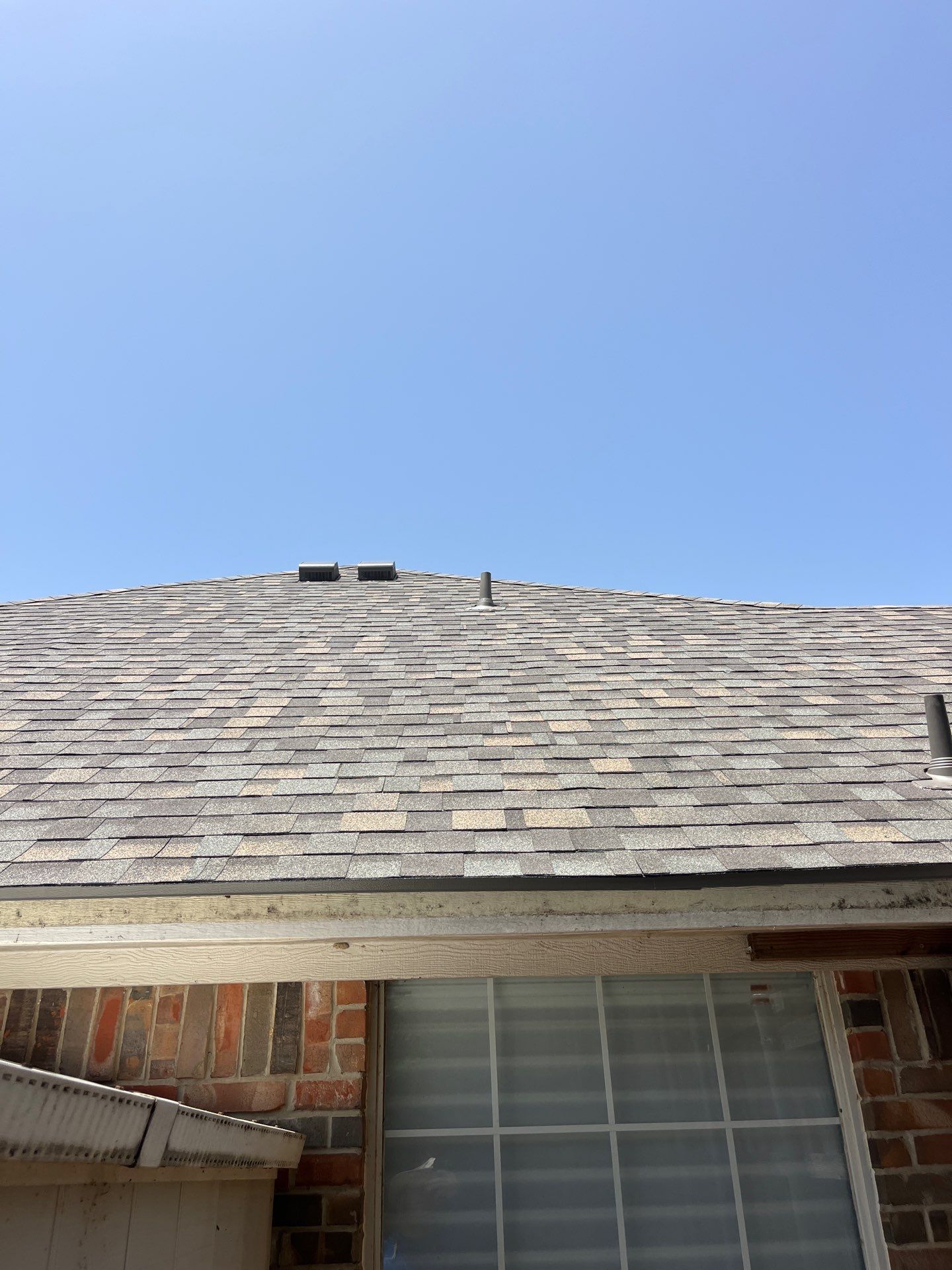 Red brick with IKO Cornerstone  by Tejas Roofworks + Restoration