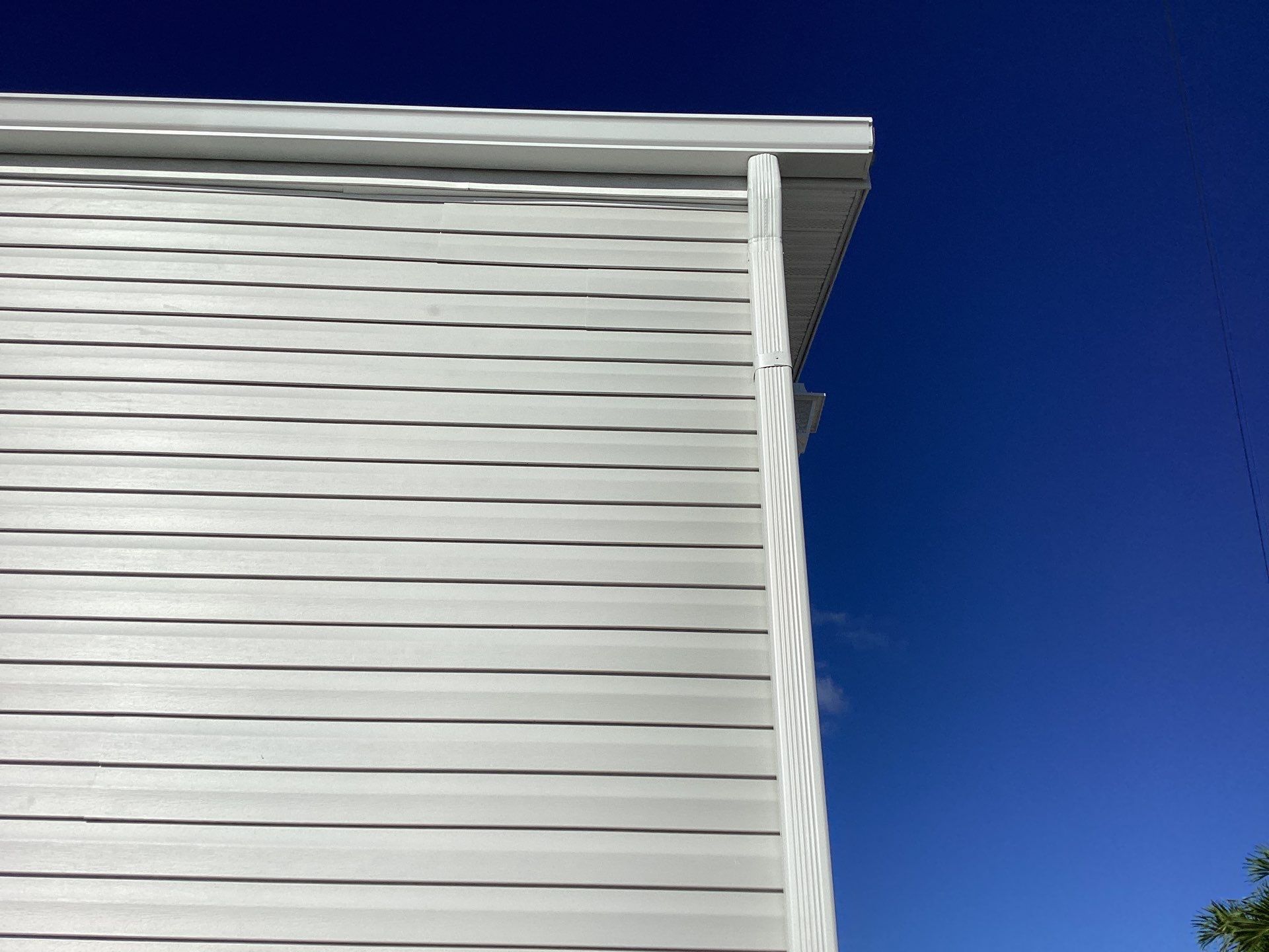 White Downspouts Installation in St. James City by Gutter Professors