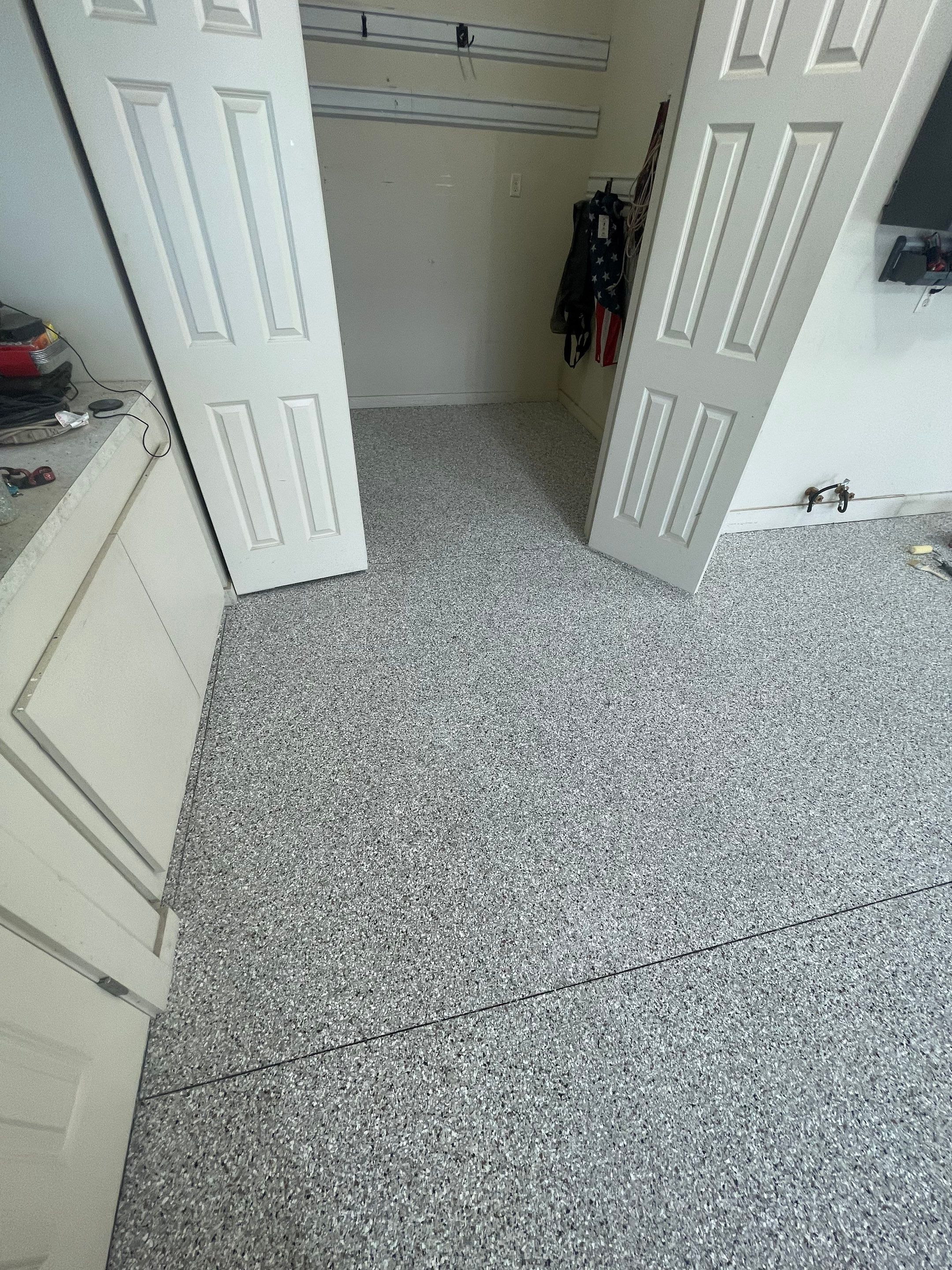 Coyote Flake Garage Floor Coating in Sioux Falls with Trench Drain by Select Painting, Coatings & Garage Cabinets