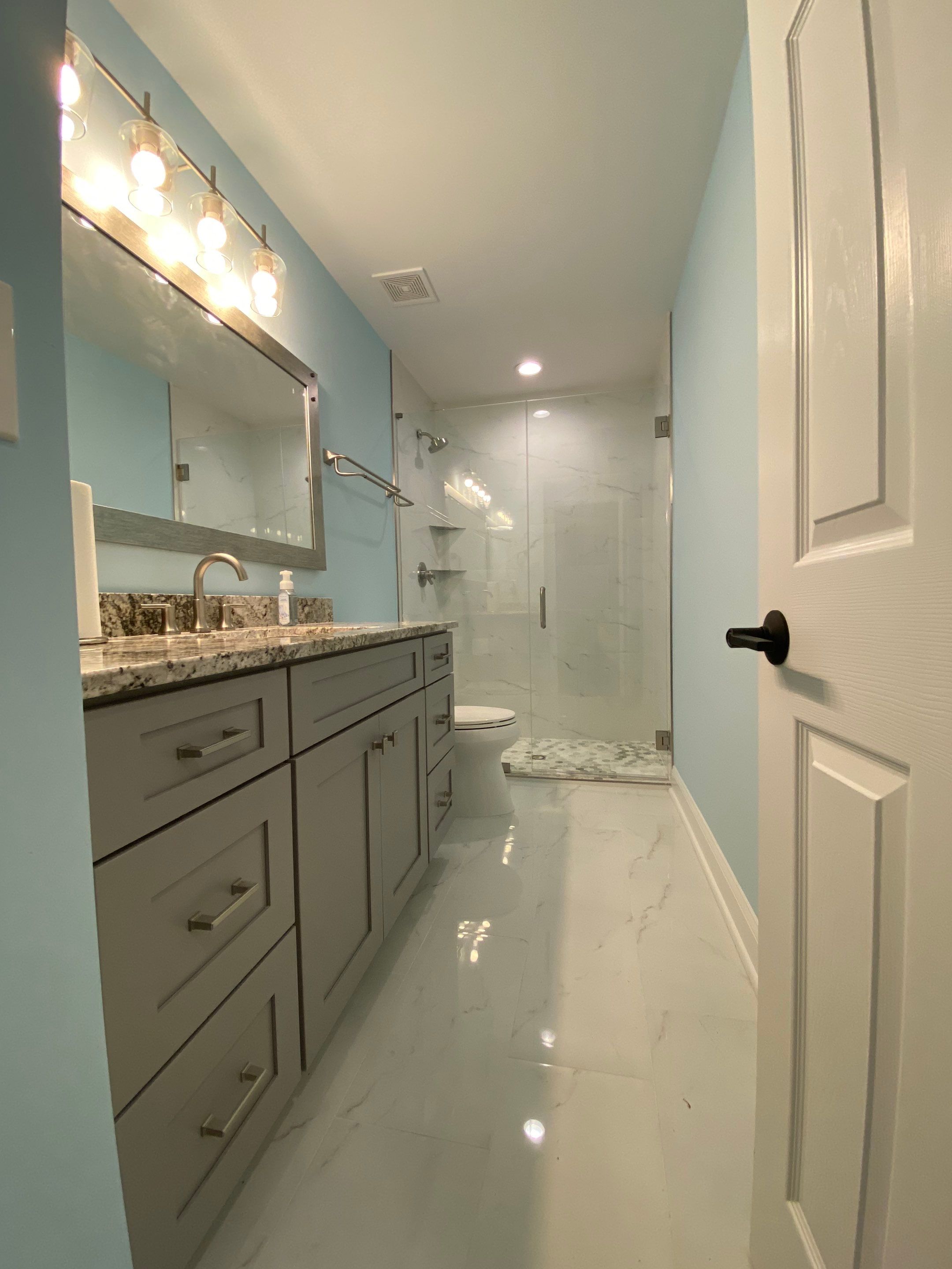 Marietta Basement Remodeling Featuring Custom Wet Bar and Marble Shower by Swift Home Renovations