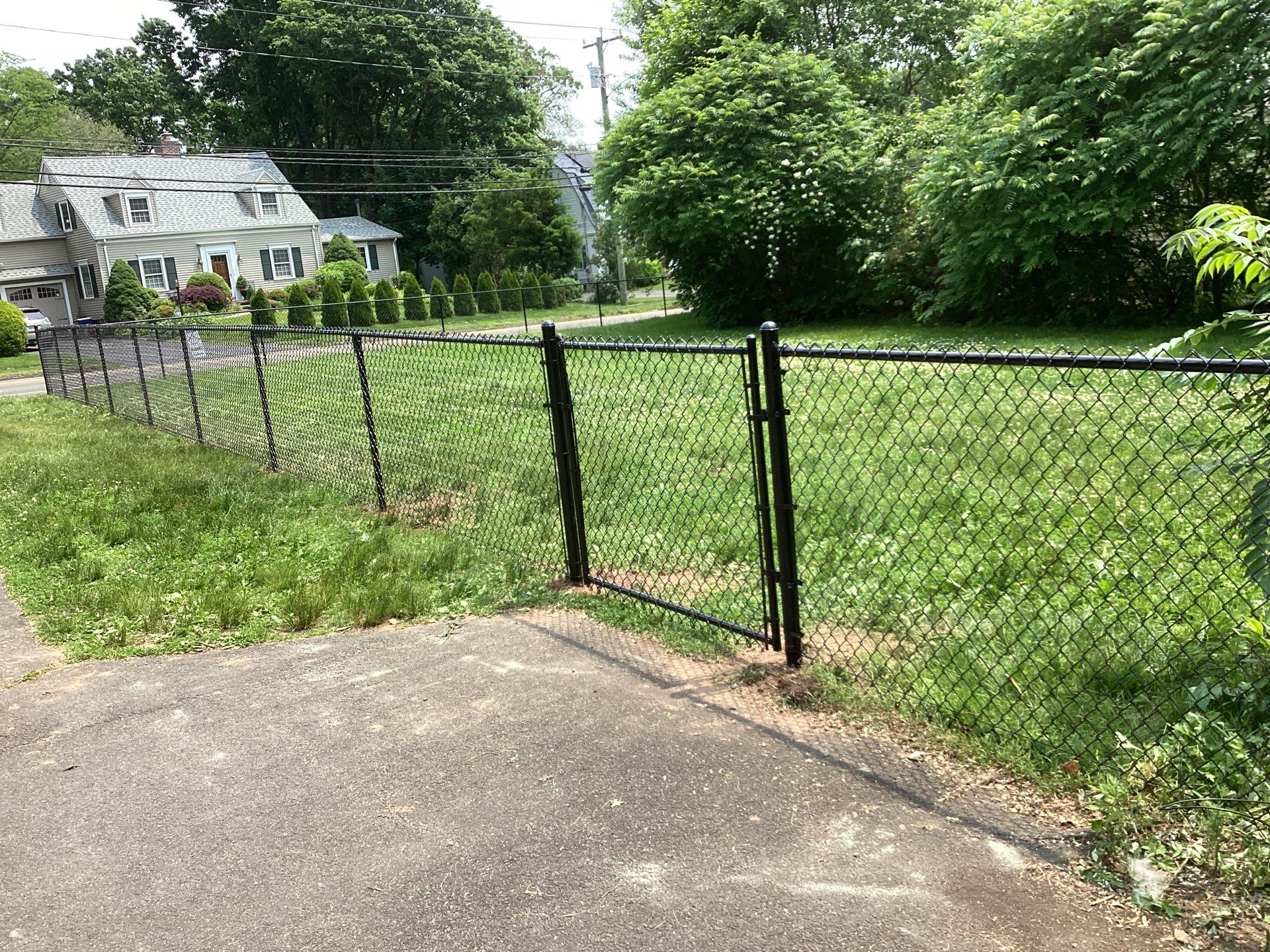 New Black Chain link fence with matching gates  by DiGiorgi Roofing and Siding Inc