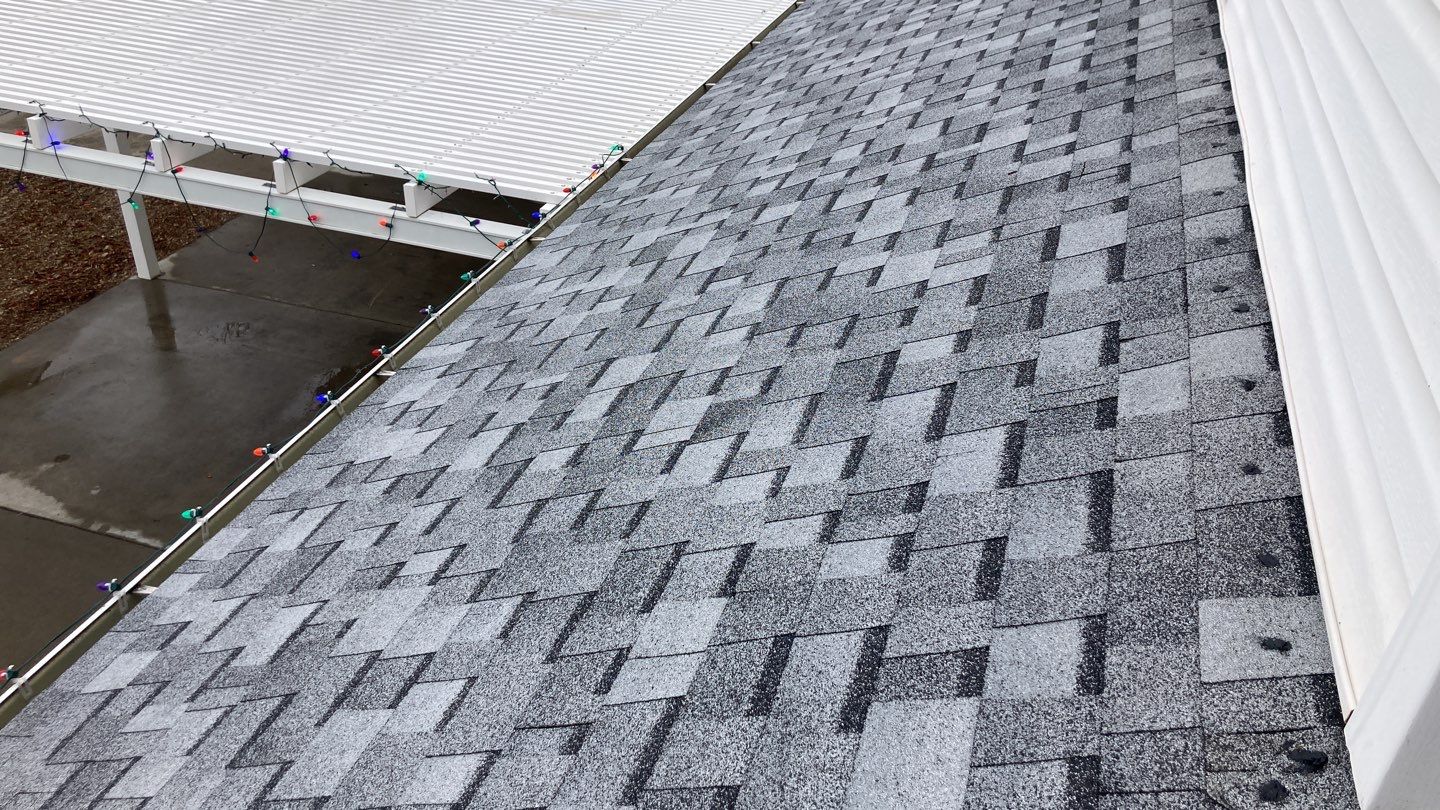 Two story farmhouse style roofing installation using Owens Corning Duration in the color Teak by ID Roofing LLC