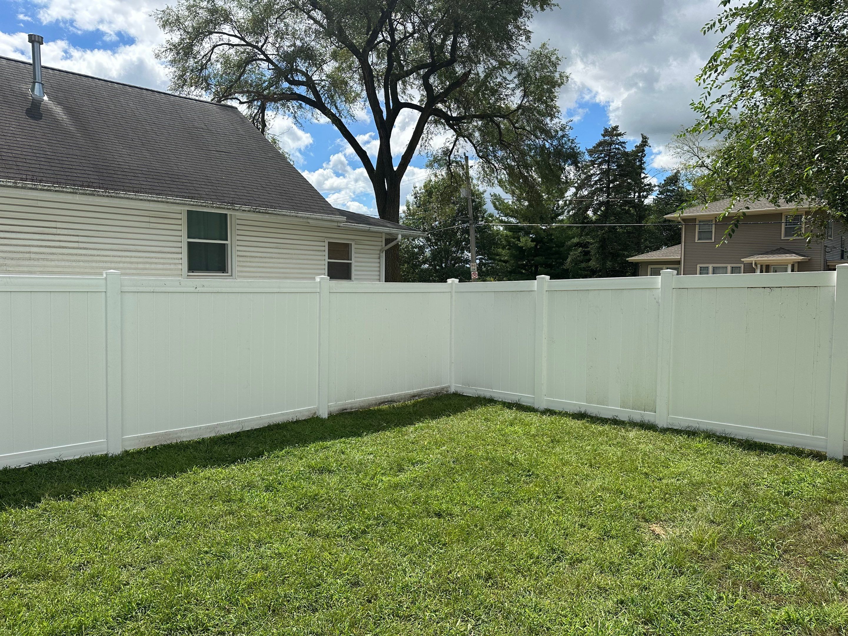 Residential White Vinyl Privacy Fence Installation in Waterloo, Iowa by Perfect Picket Fence and Stain