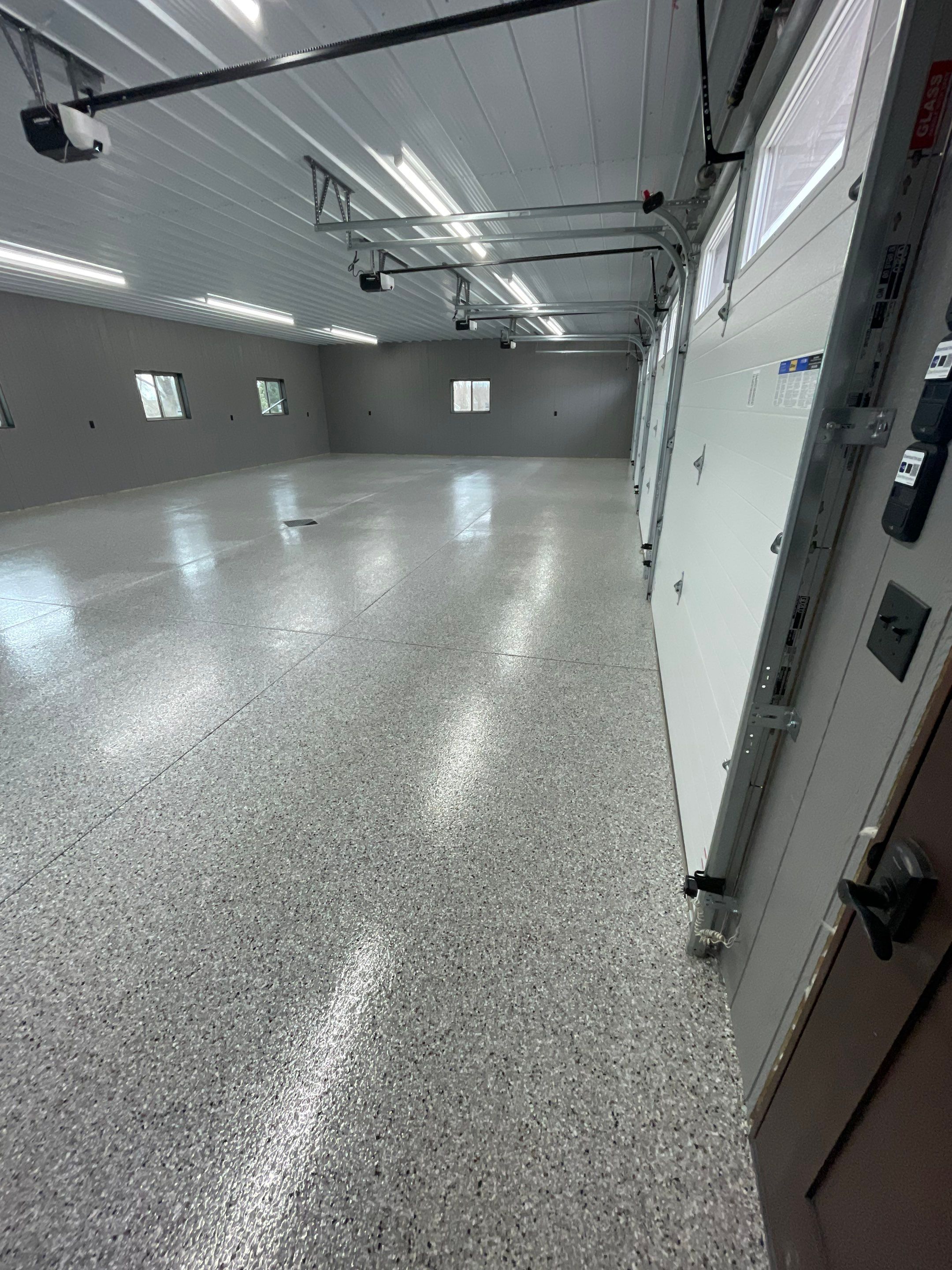Speckled Epoxy Floor Coating for Large Shop in Rock Valley by Select Painting, Coatings & Garage Cabinets