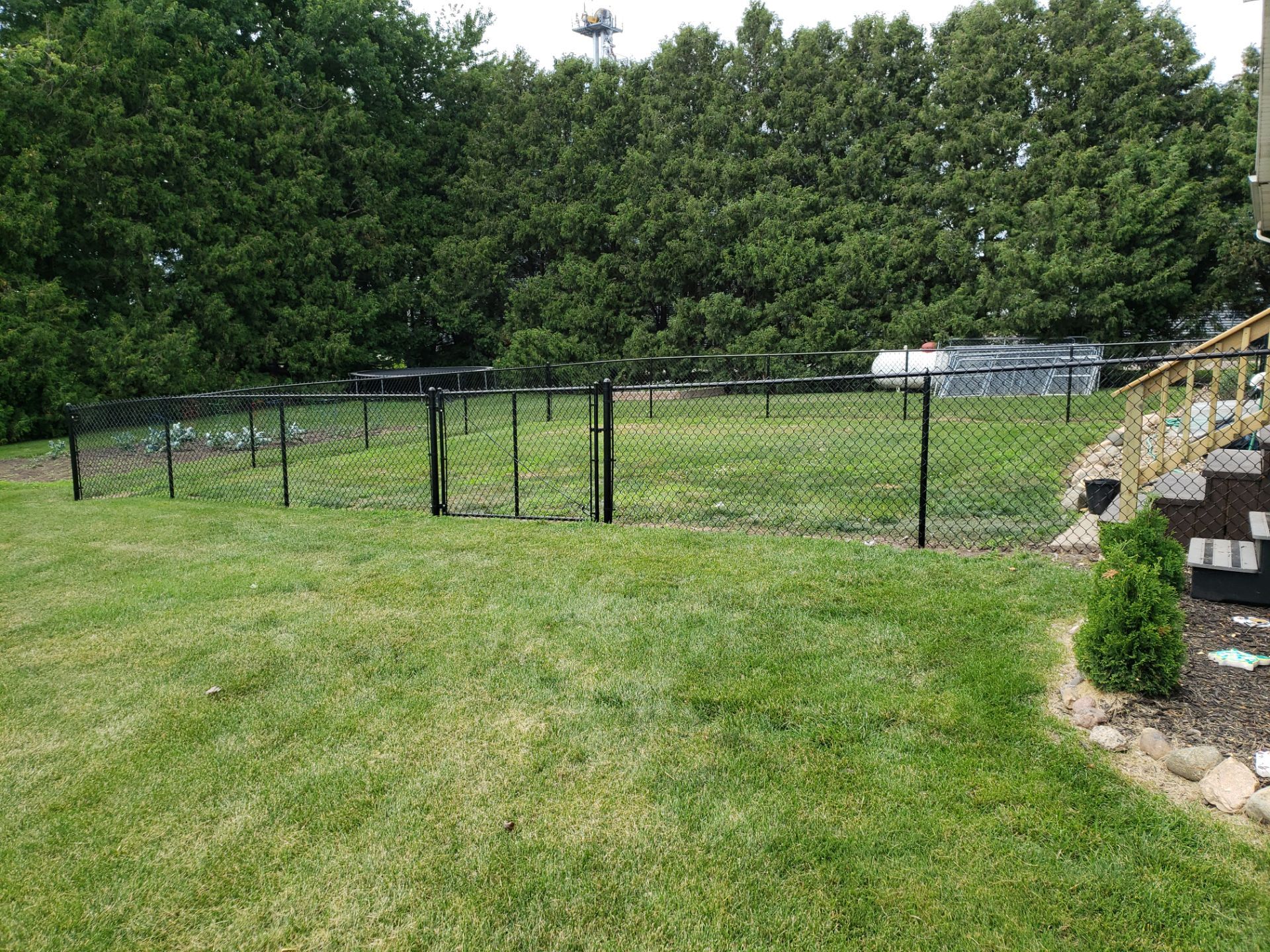 Black Vinyl-Coated Chain Link Fence Installation in Fredericksburg by Perfect Picket Fence and Stain