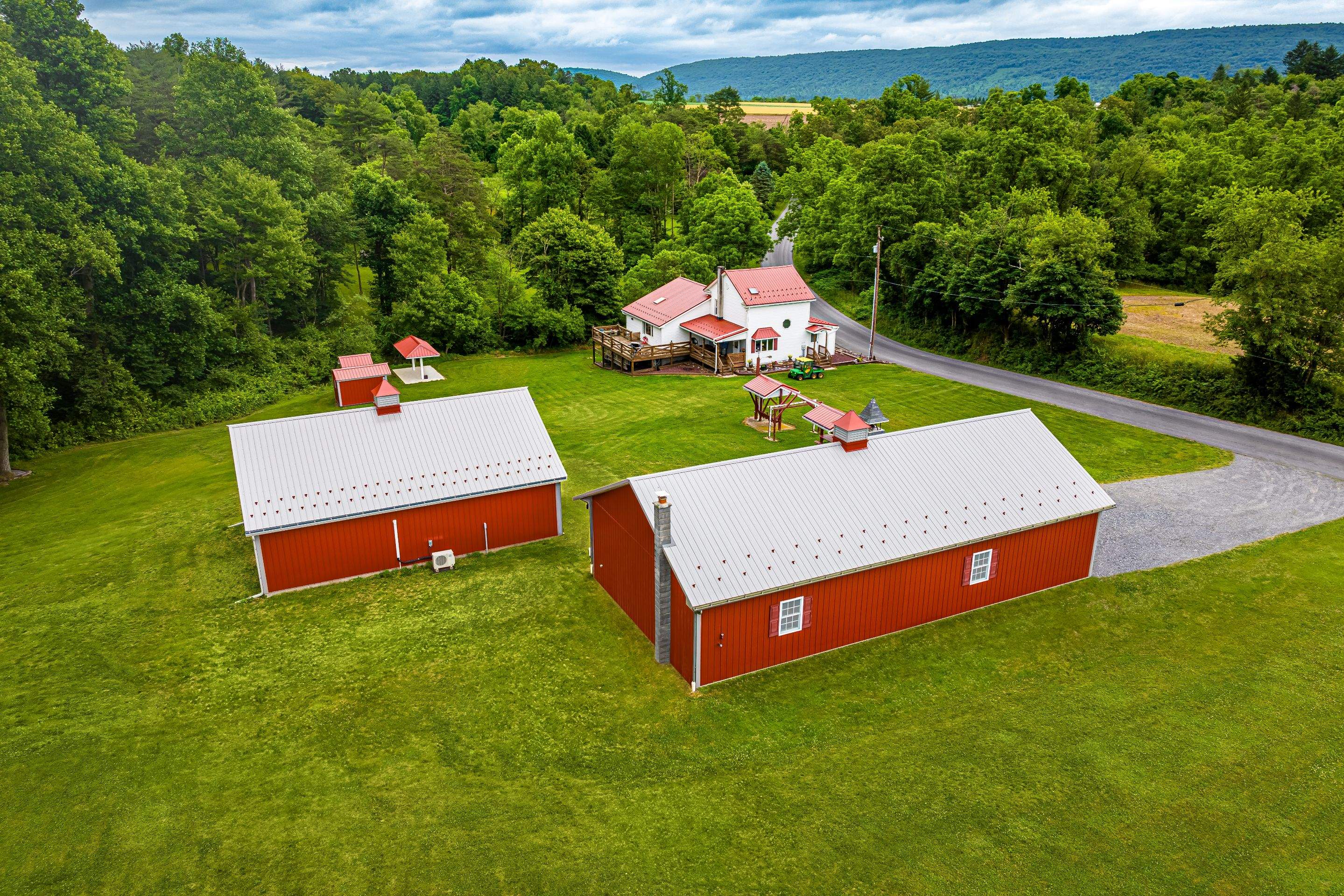 Metal roof -barn red, and New garage by Esh Builders