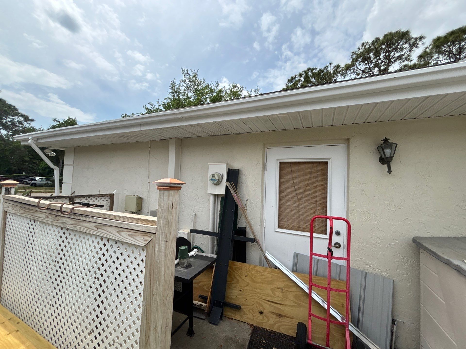 Gutter Project with White 6-K Seamless Gutters Installation and Downspouts in Sarasota FL by Gutter Professors