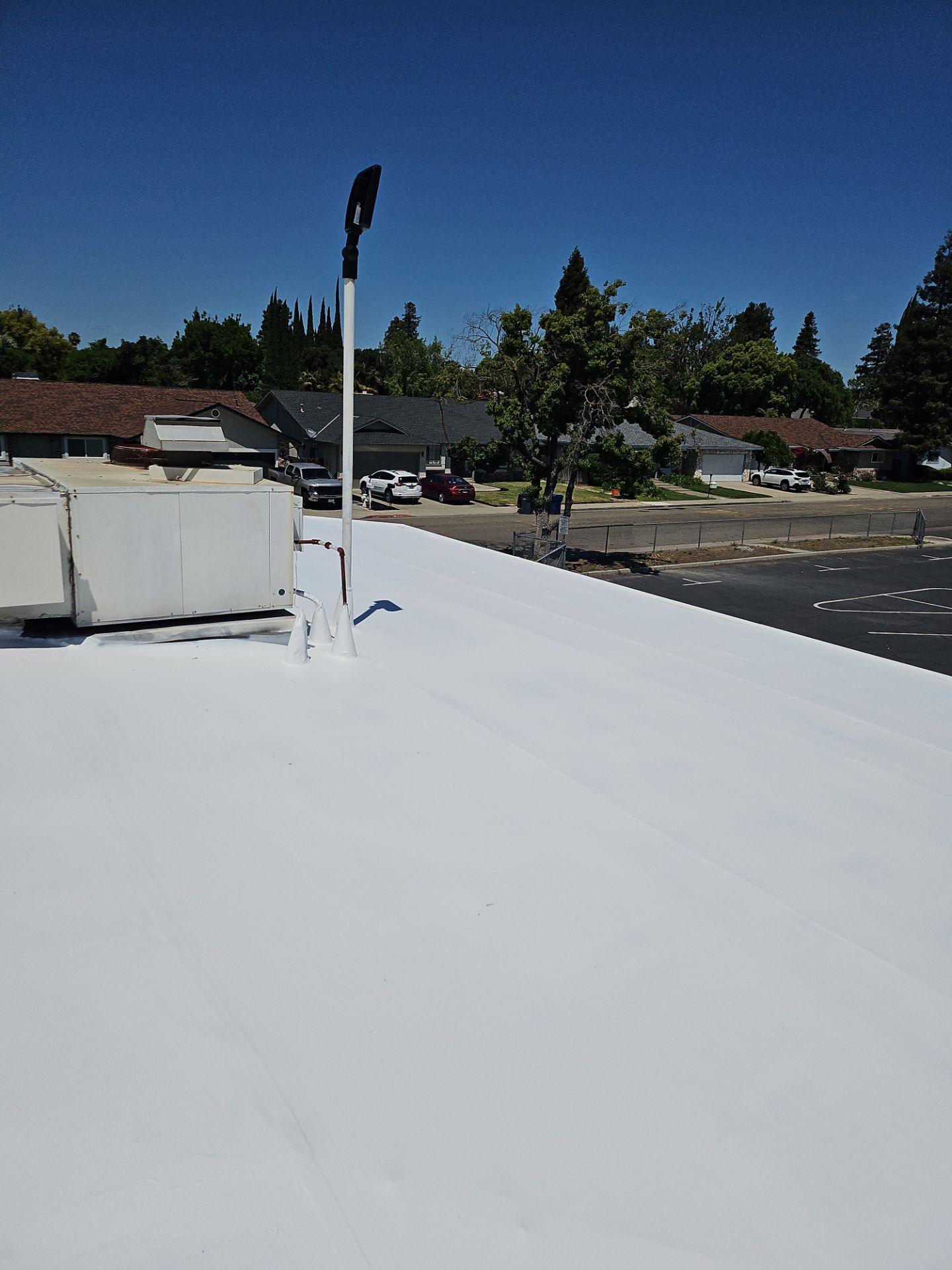 Single-ply restoration system using Benchmark/PUMA XL coatings over TPO single-ply roofing by Straight Edge Roofing Inc