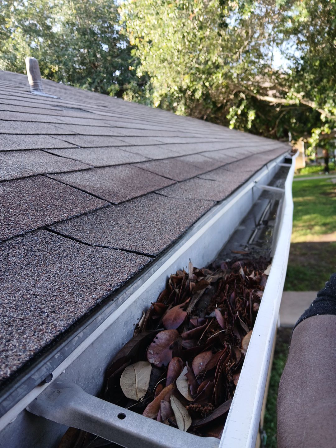 Commercial gutter cleaning Laredo, TX before photo with filled gutters