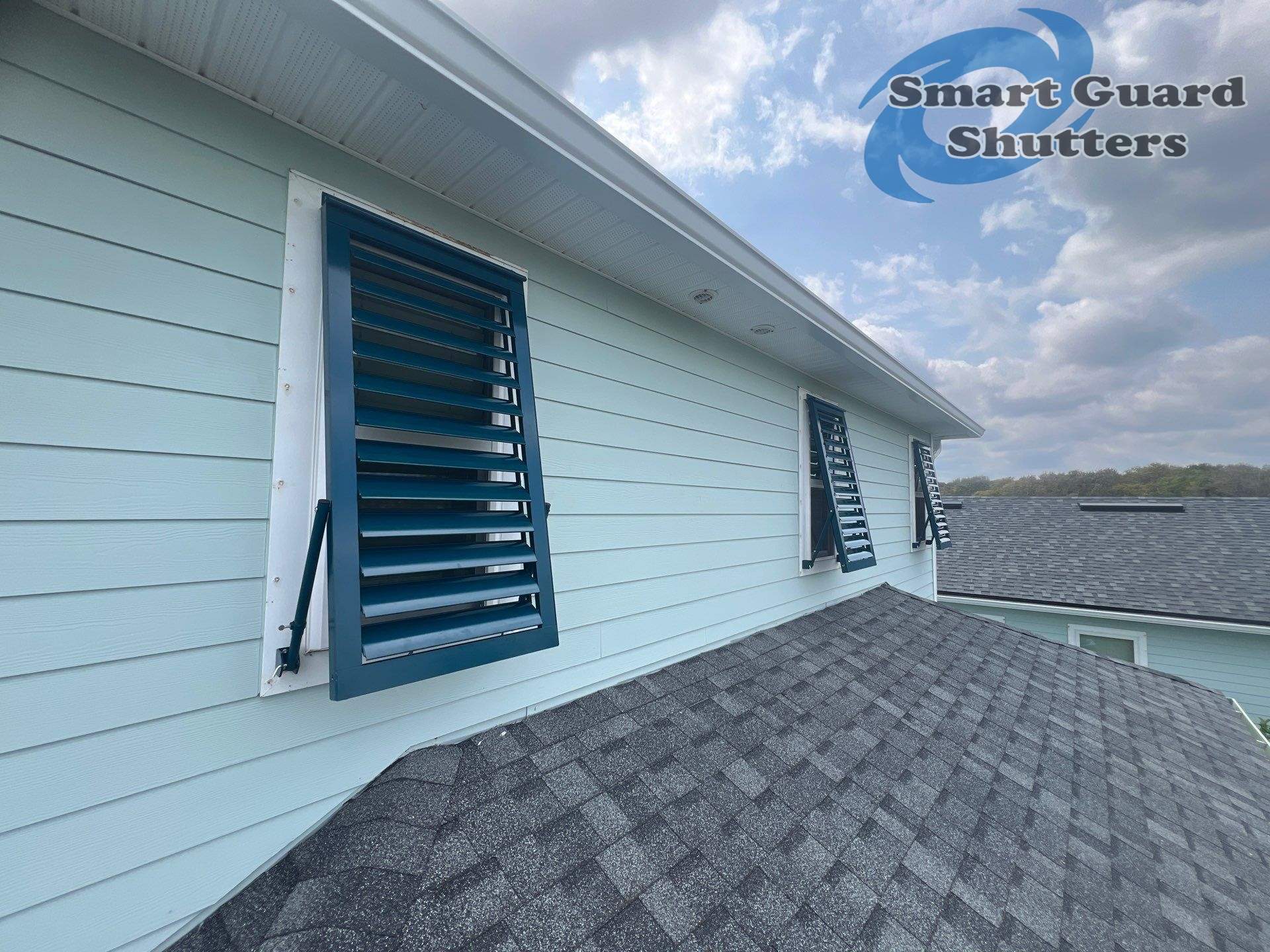 Impact Bahamas in Ocean Blue, Accordion in White by Smart Guard Shutters