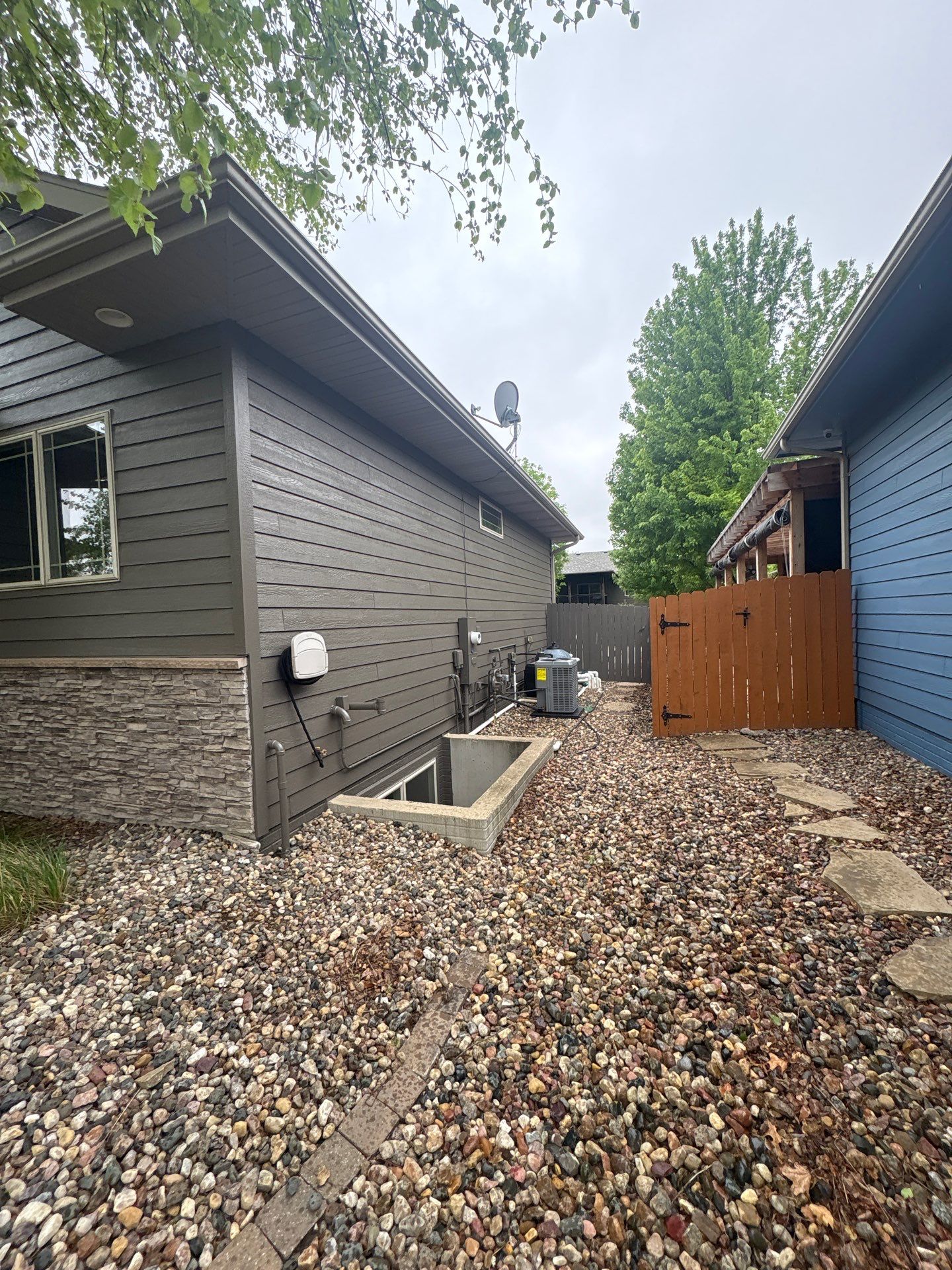 Sioux Falls Residential Exterior Update and Flagstone Pool Deck by Select Painting, Coatings & Garage Cabinets