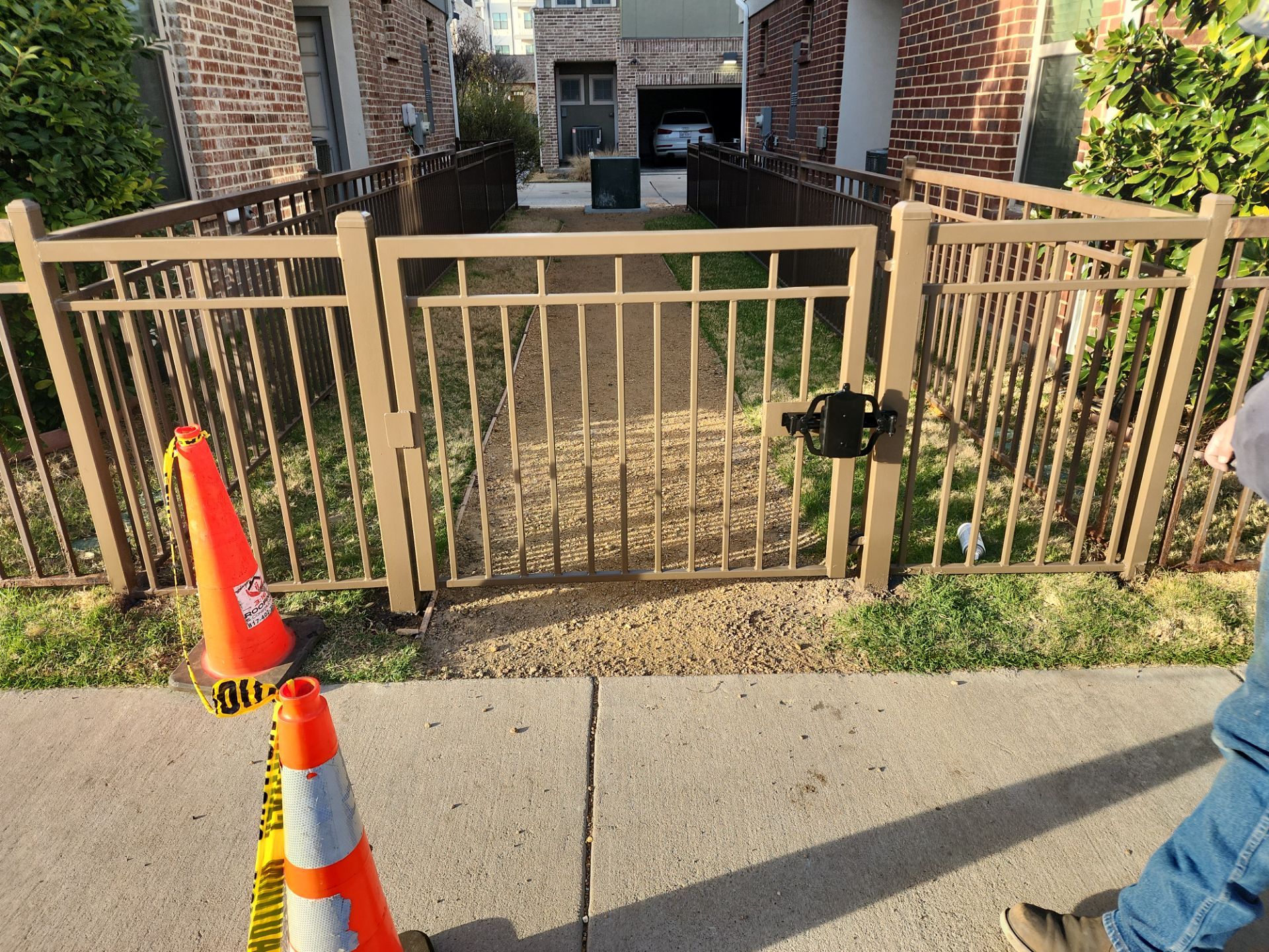 Arbor with Wrought Iron Fencing by 3:16 Roofing and Construction