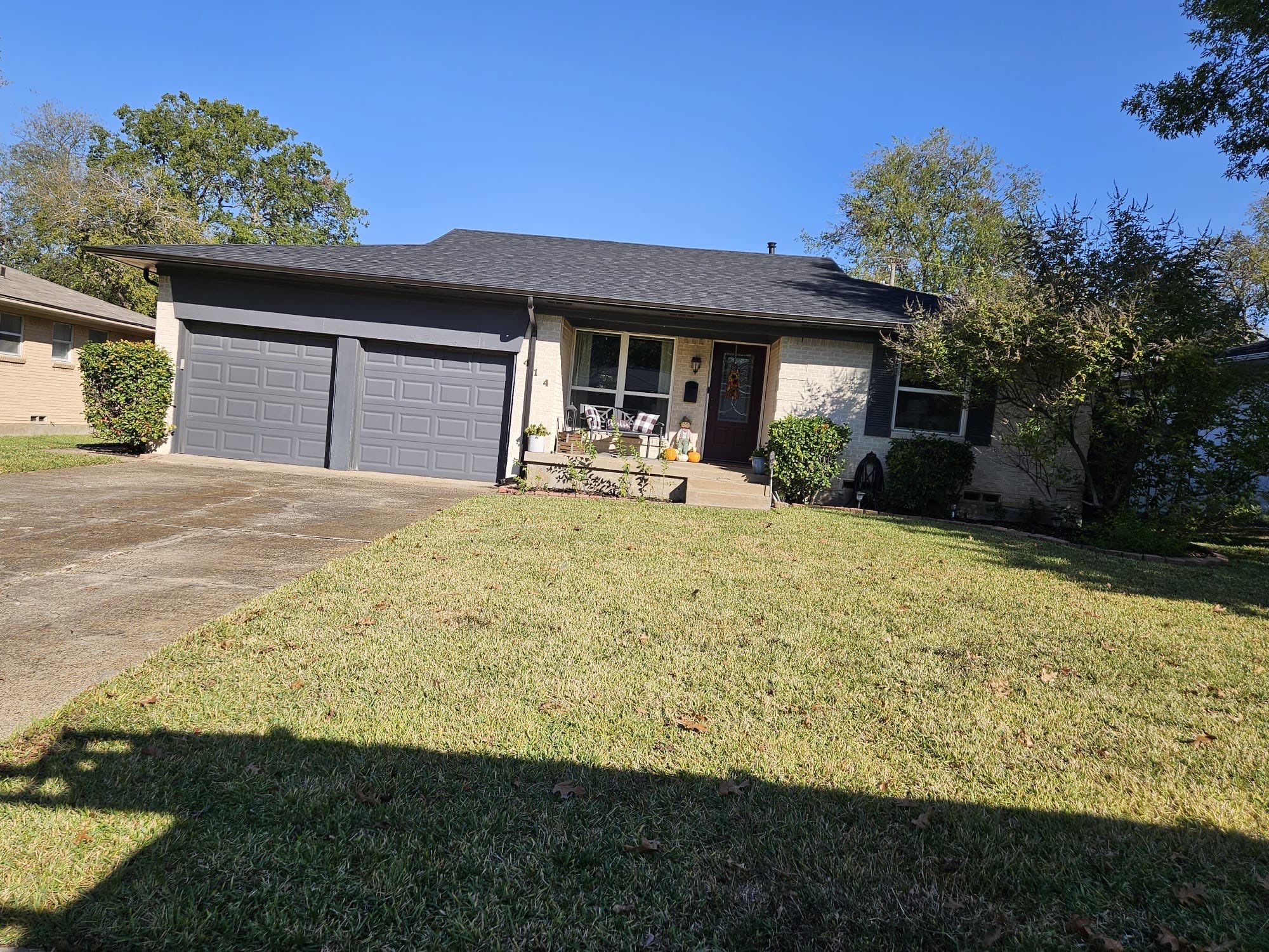White brick/black accents with IKO Granite Black by Tejas Roofworks + Restoration
