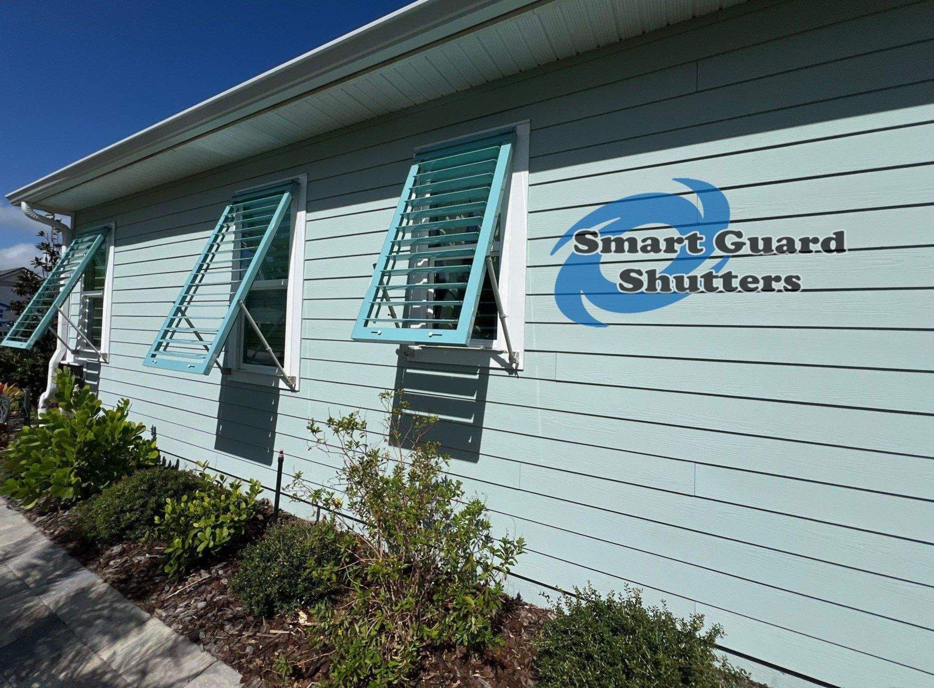 Impact Bahama Shutters in Pastel Turquoise by Smart Guard Shutters
