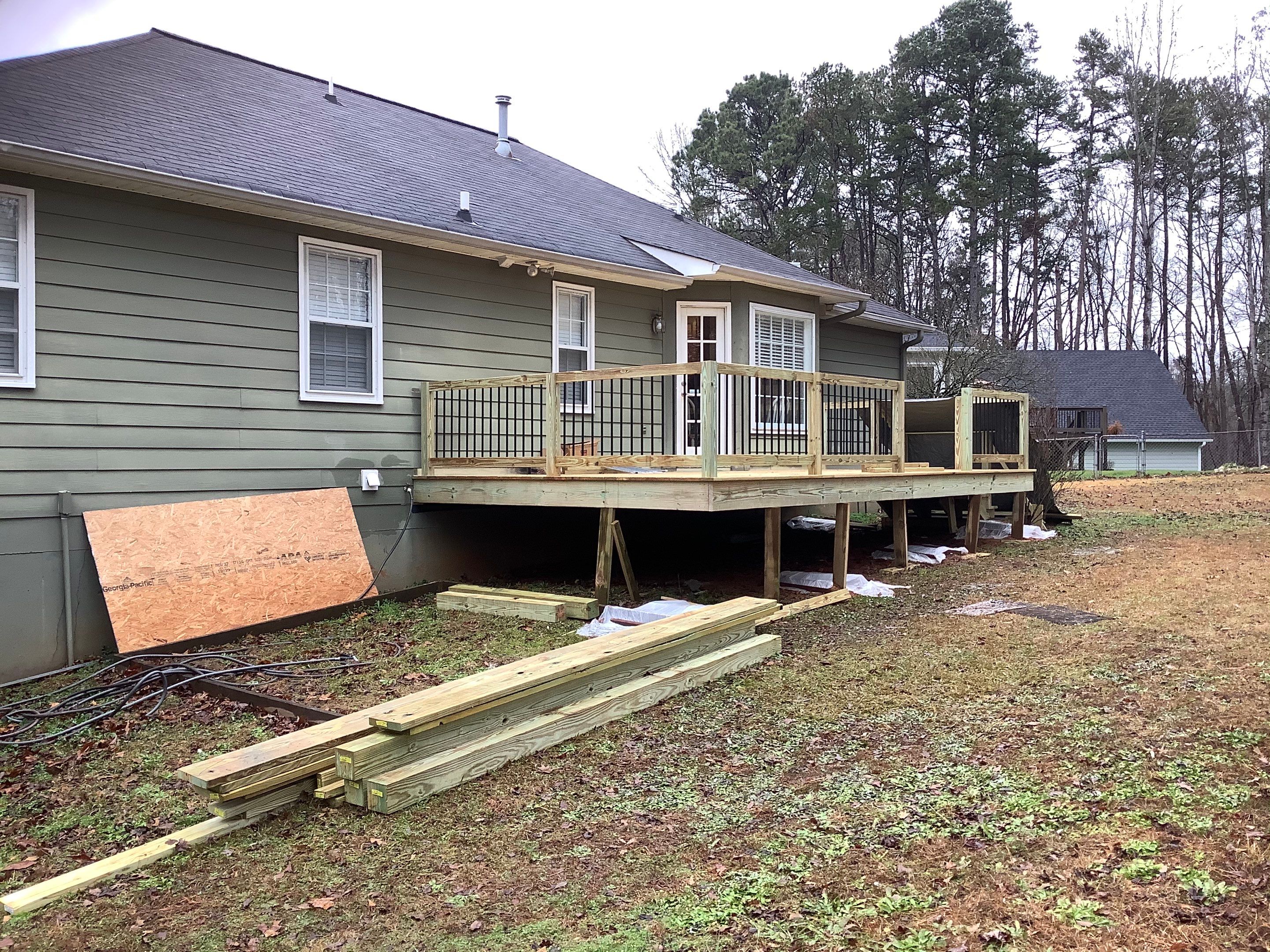Raised Pressure-Treated Wood Deck Construction in Dallas, Georgia by Swift Home Renovations 