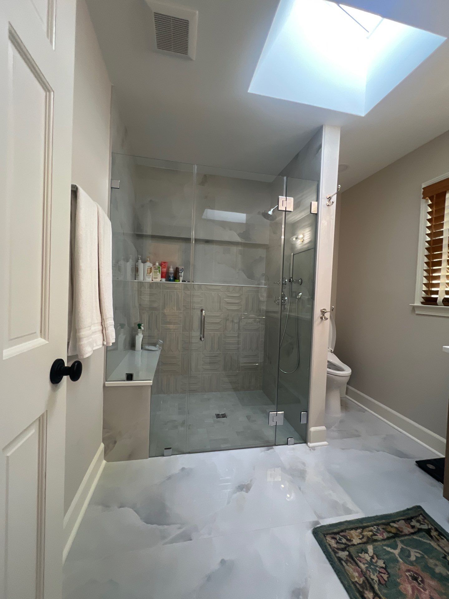 Modern Bathroom Remodeling Featuring Marble Tiles and Custom Cabinetry in Smyrna by Swift Home Renovations